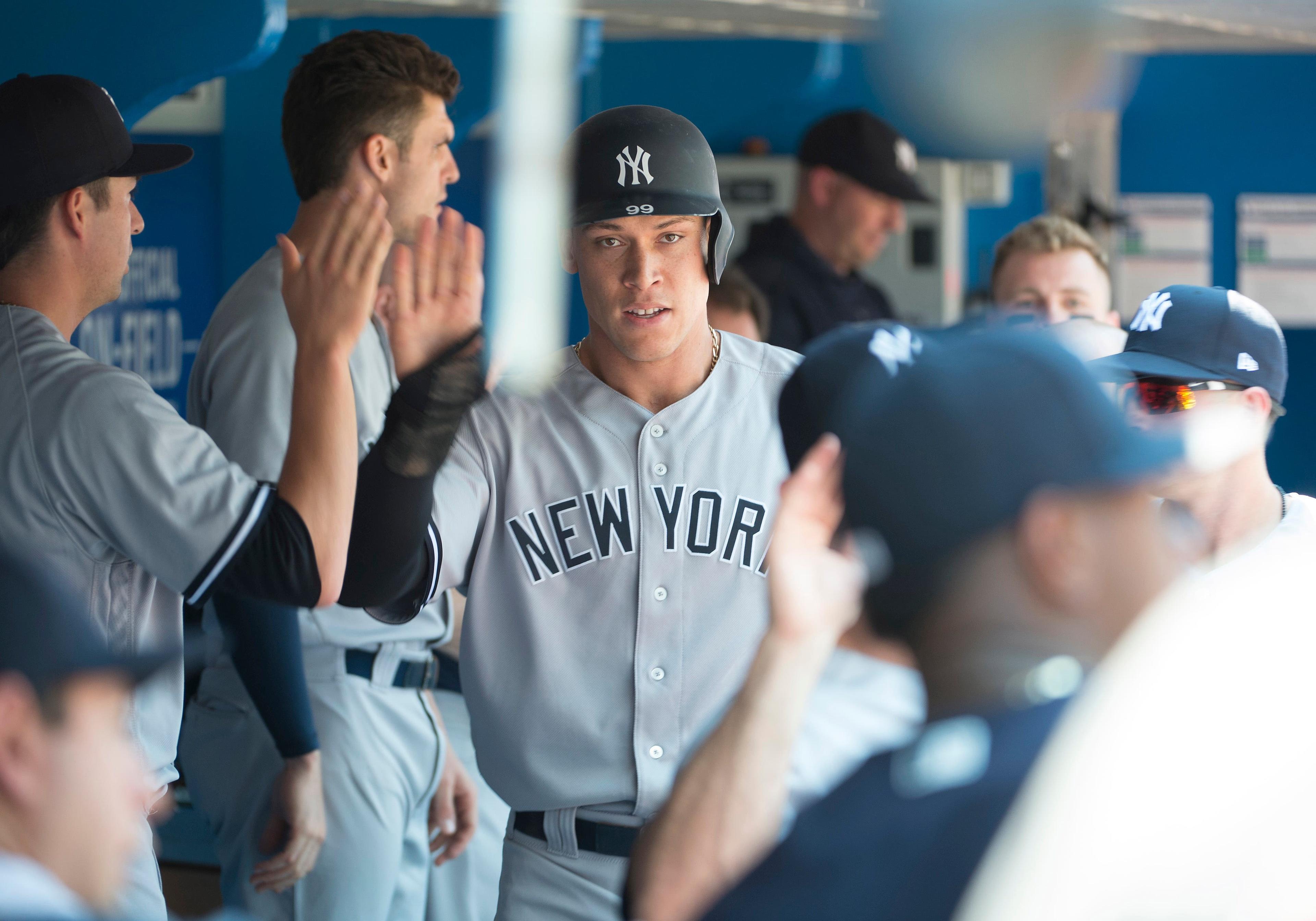 New York Yankees right fielder Aaron Judge celebrates in the dugout after scoring a run during the first inning against the Toronto Blue Jays at Rogers Centre. / Nick Turchiaro/USA TODAY Sports