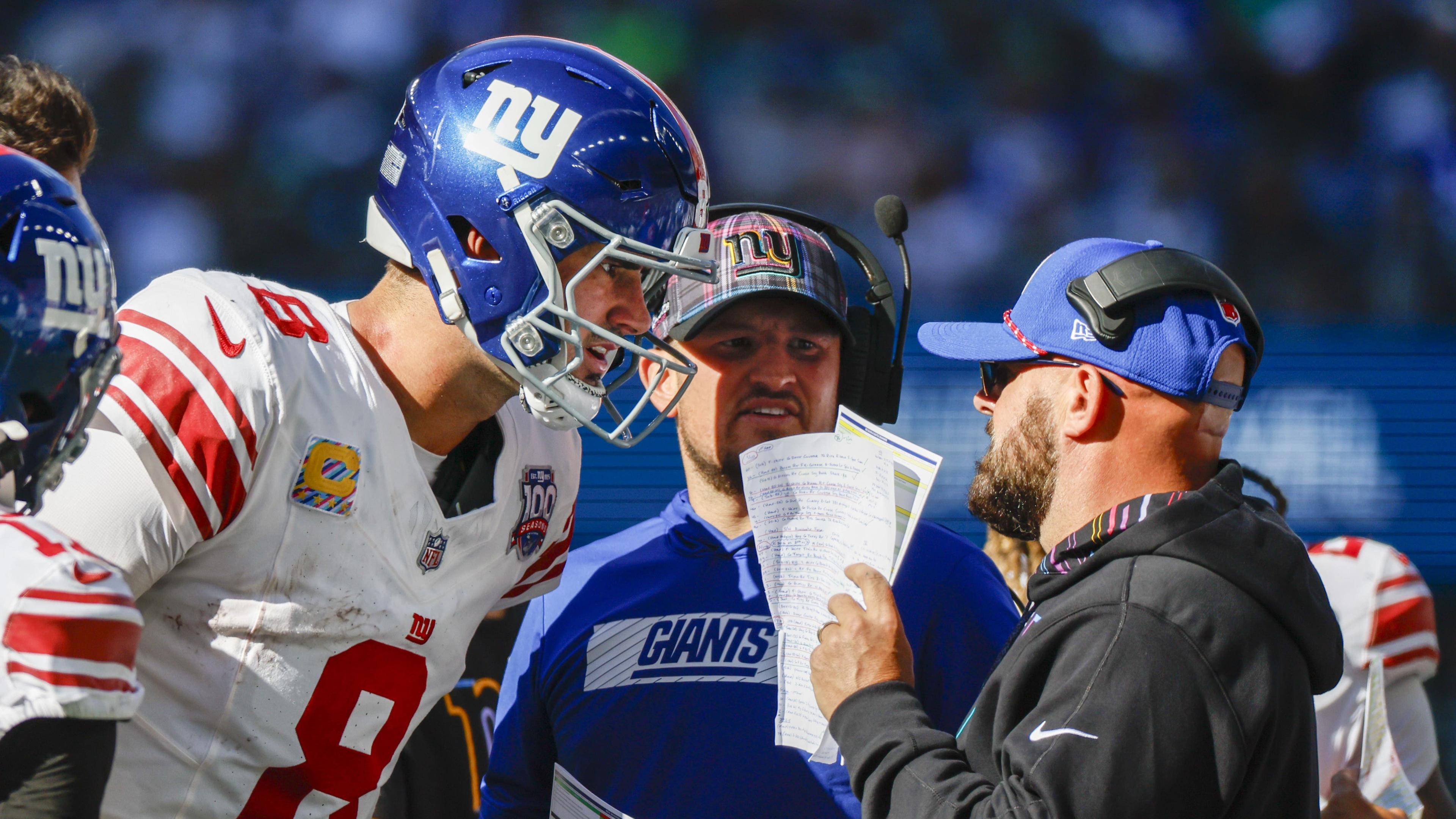  New York Giants quarterback Daniel Jones (8) talks with head coach Brian Daboll, right) during the second quarter against the Seattle Seahawks at Lumen Field. New York Giants quarterbacks coach Shea Tierney stands in the middle. 