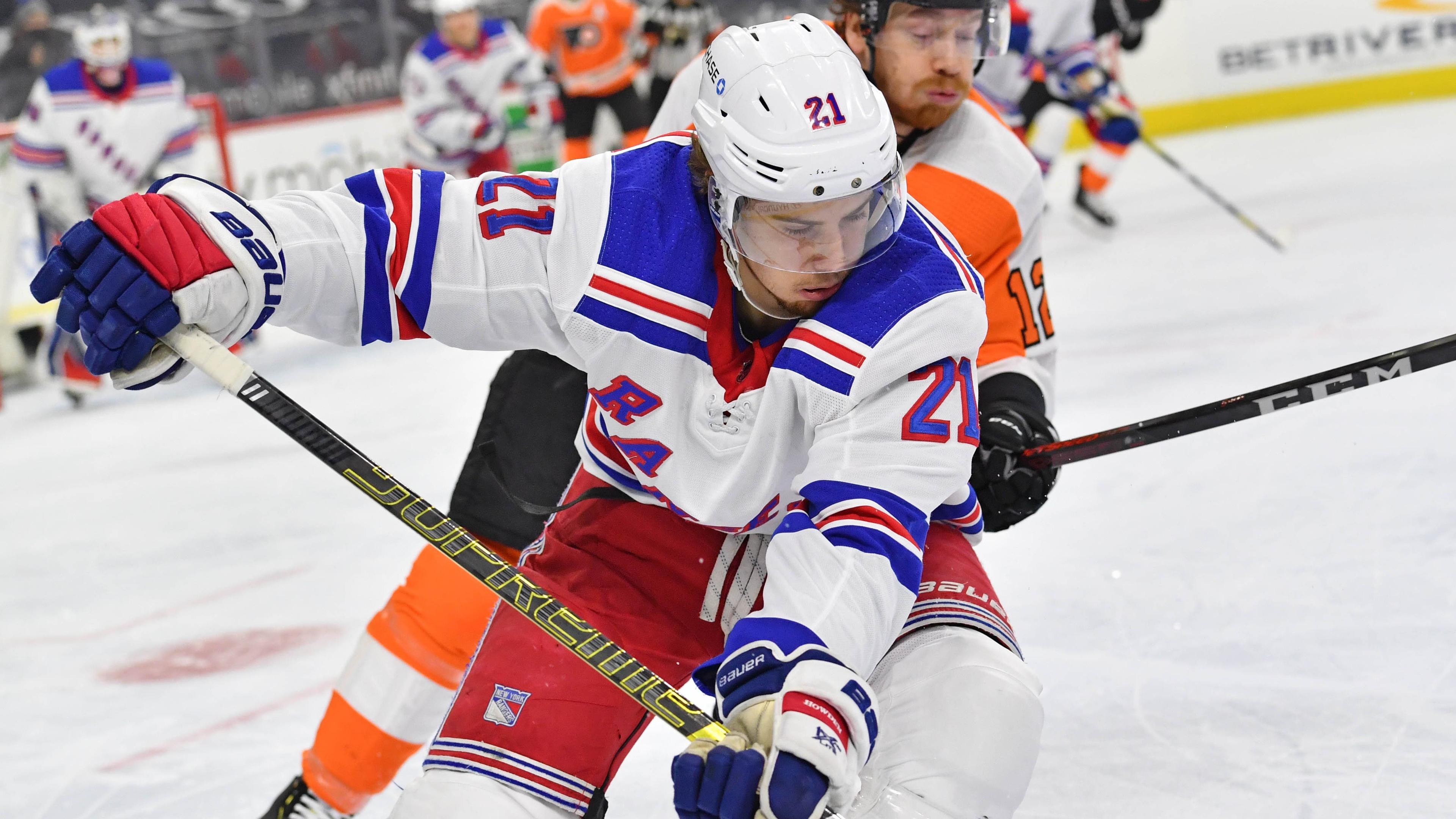 Feb 18, 2021; Philadelphia, Pennsylvania, USA; New York Rangers center Brett Howden (21) carries the puck against Philadelphia Flyers left wing Michael Raffl (12) during the first period at Wells Fargo Center. / © Eric Hartline-USA TODAY Sports