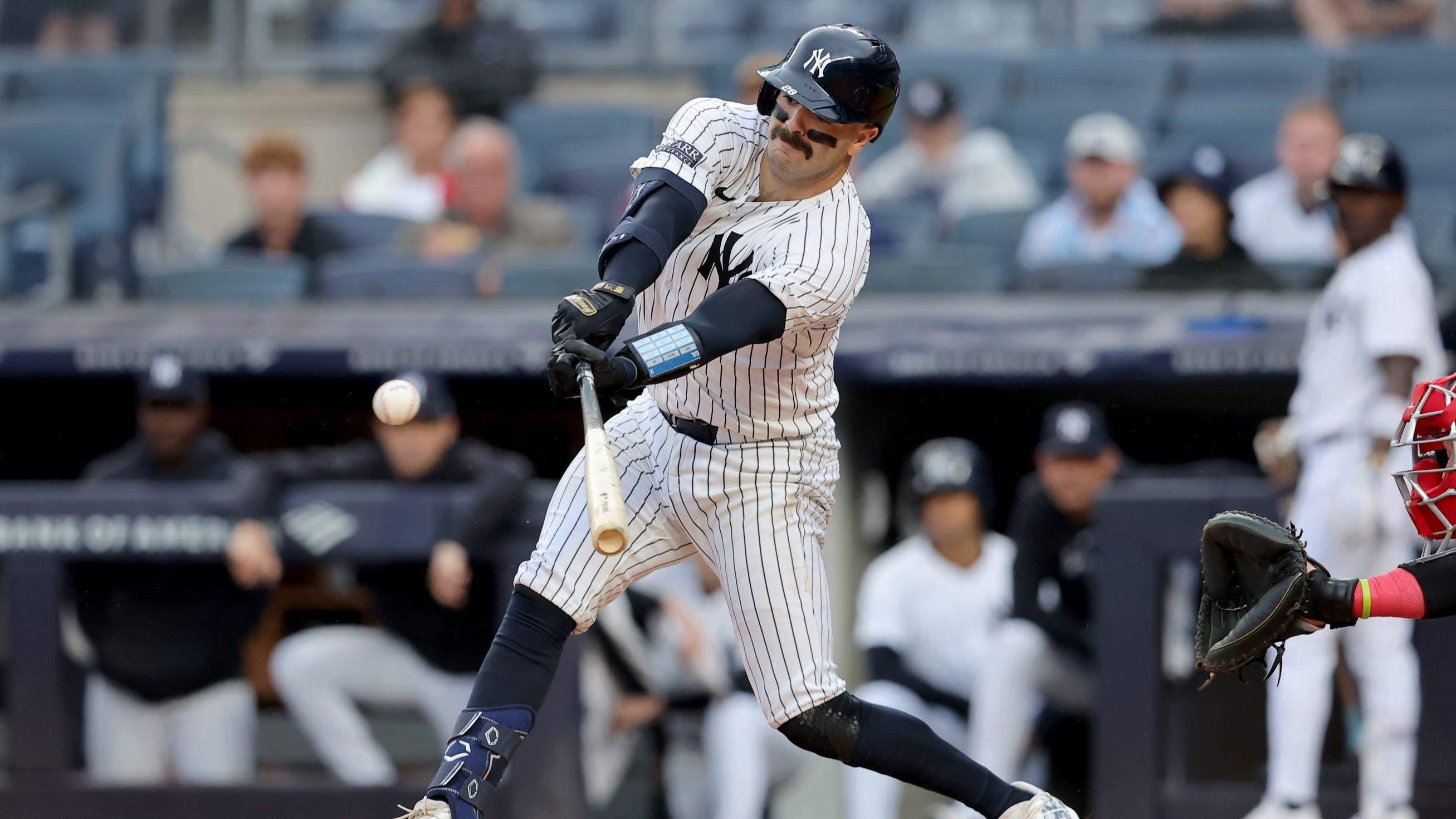 Aug 7, 2024; Bronx, New York, USA; New York Yankees catcher Austin Wells (28) hits an RBI single against the Los Angeles Angels during the first inning at Yankee Stadium / Brad Penner-USA TODAY Sports