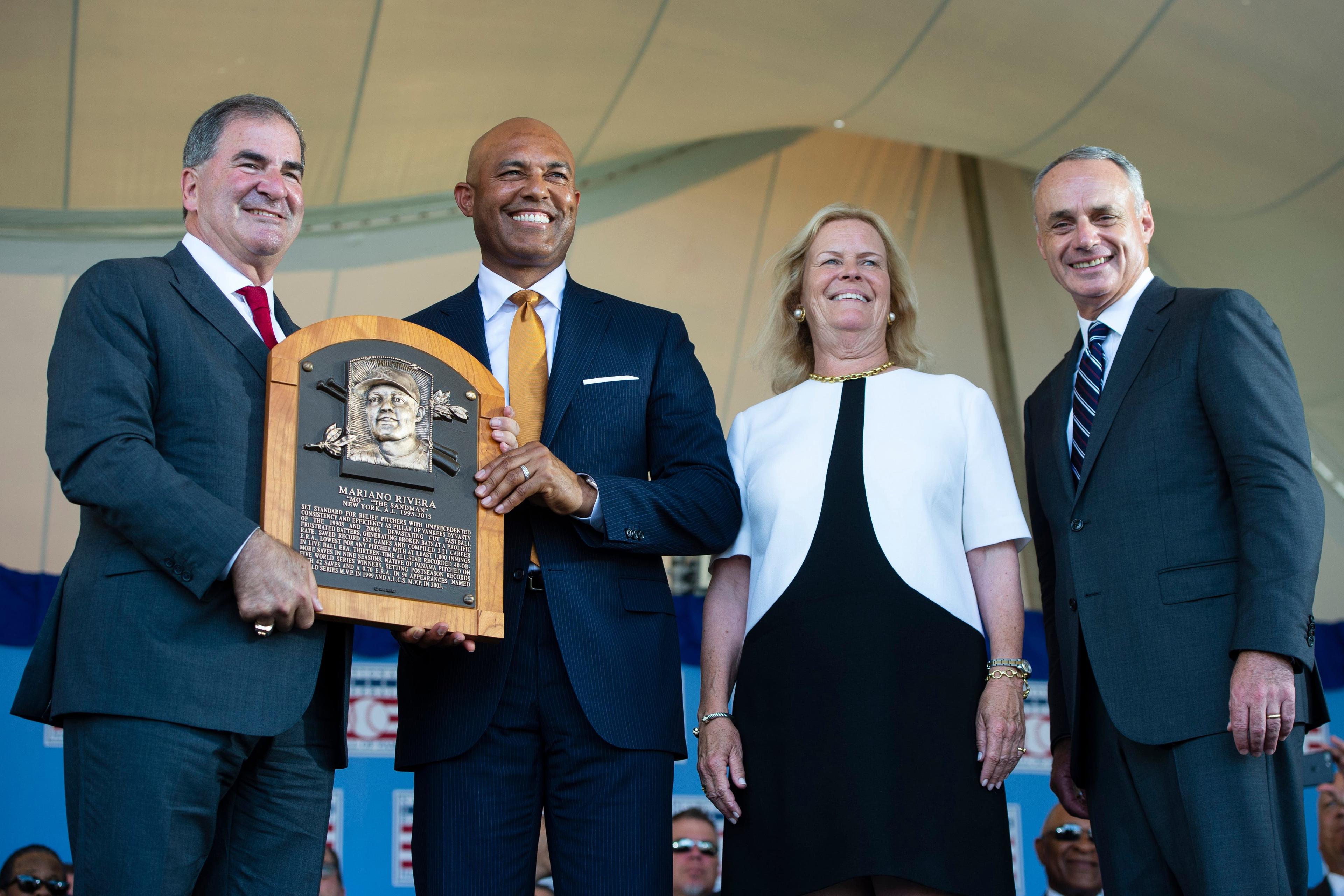 Jul 21, 2019; Cooperstown, NY, USA; Hall of Fame President Tim Mead and Hall of Fame Inductee Mariano Rivera hold the Hall of Fame plaque along with National baseball hall of fame chairman of the board Jane Forbes Clark and Baseball Commissioner Rob Manfred during the 2019 National Baseball Hall of Fame induction ceremony at the Clark Sports Center. Mandatory Credit: Gregory J. Fisher-USA TODAY Sports / Gregory Fisher