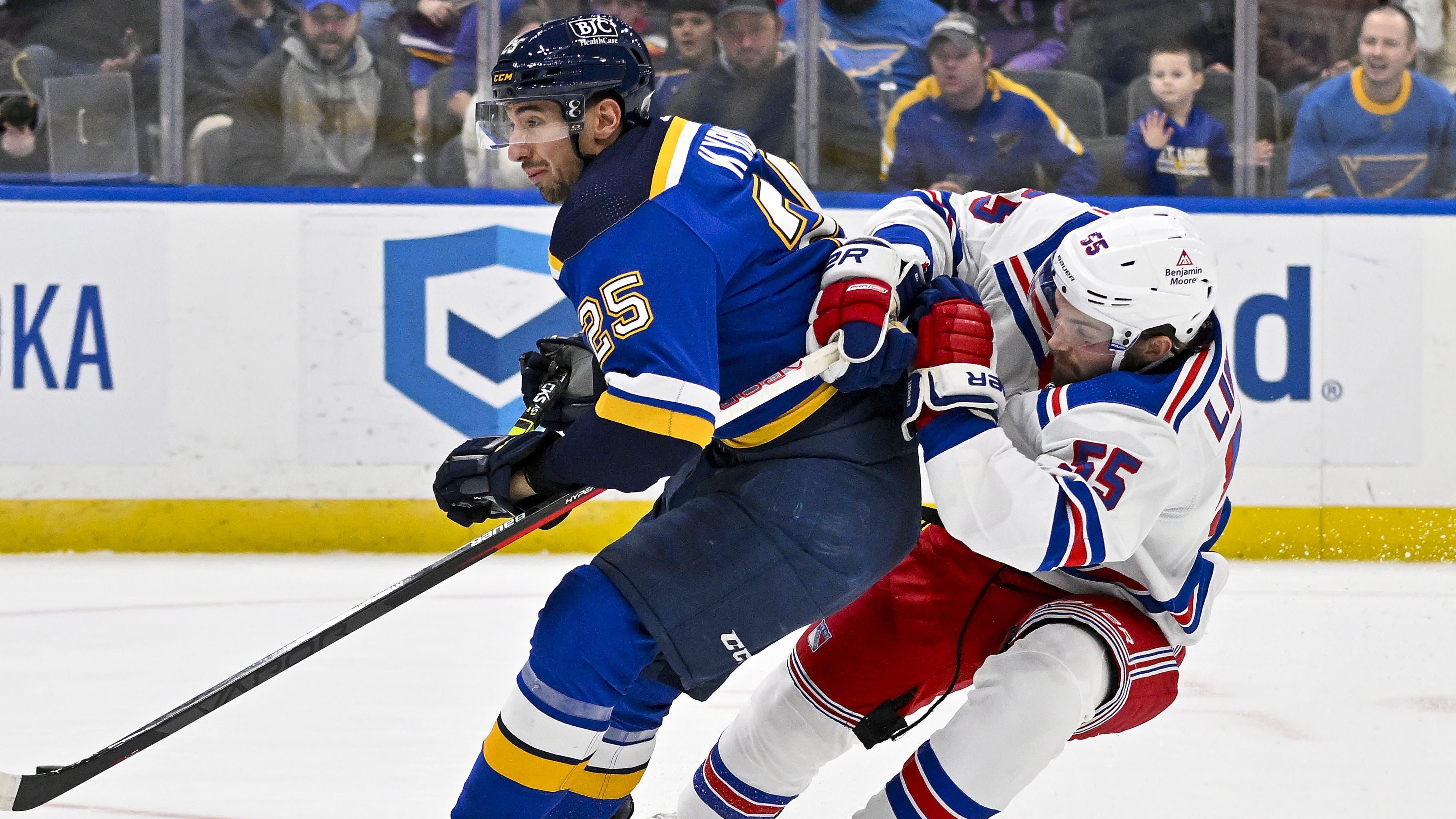 New York Rangers defenseman Ryan Lindgren (55) defends against St. Louis Blues center Jordan Kyrou (25) during the second period at Enterprise Center / Jeff Curry - USA TODAY Sports