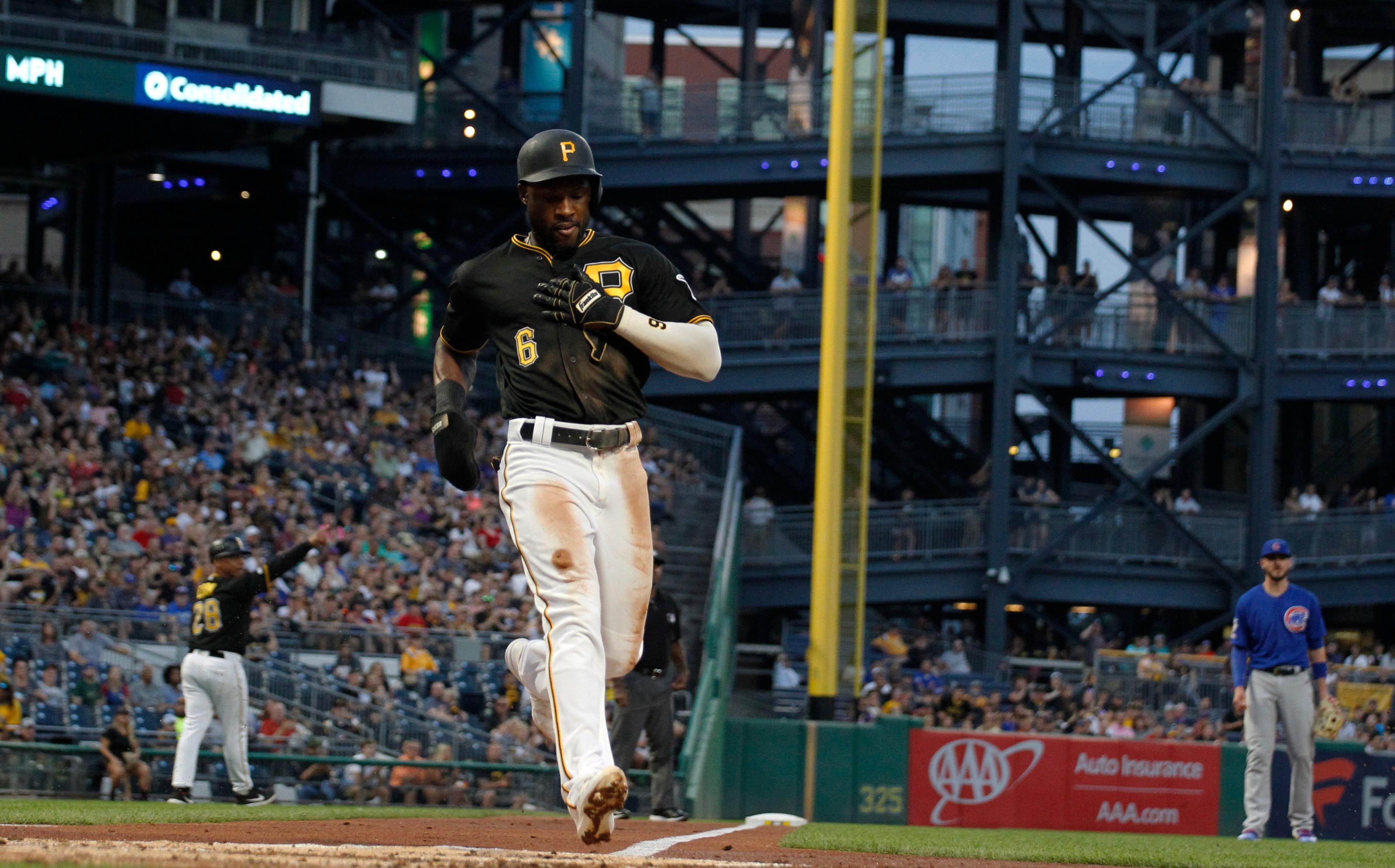 Aug 16, 2019; Pittsburgh, PA, USA; Pittsburgh Pirates center fielder Starling Marte (6) crosses home plate to score a run against the Chicago Cubs during the fourth inning at PNC Park. Mandatory Credit: Charles LeClaire-USA TODAY Sports