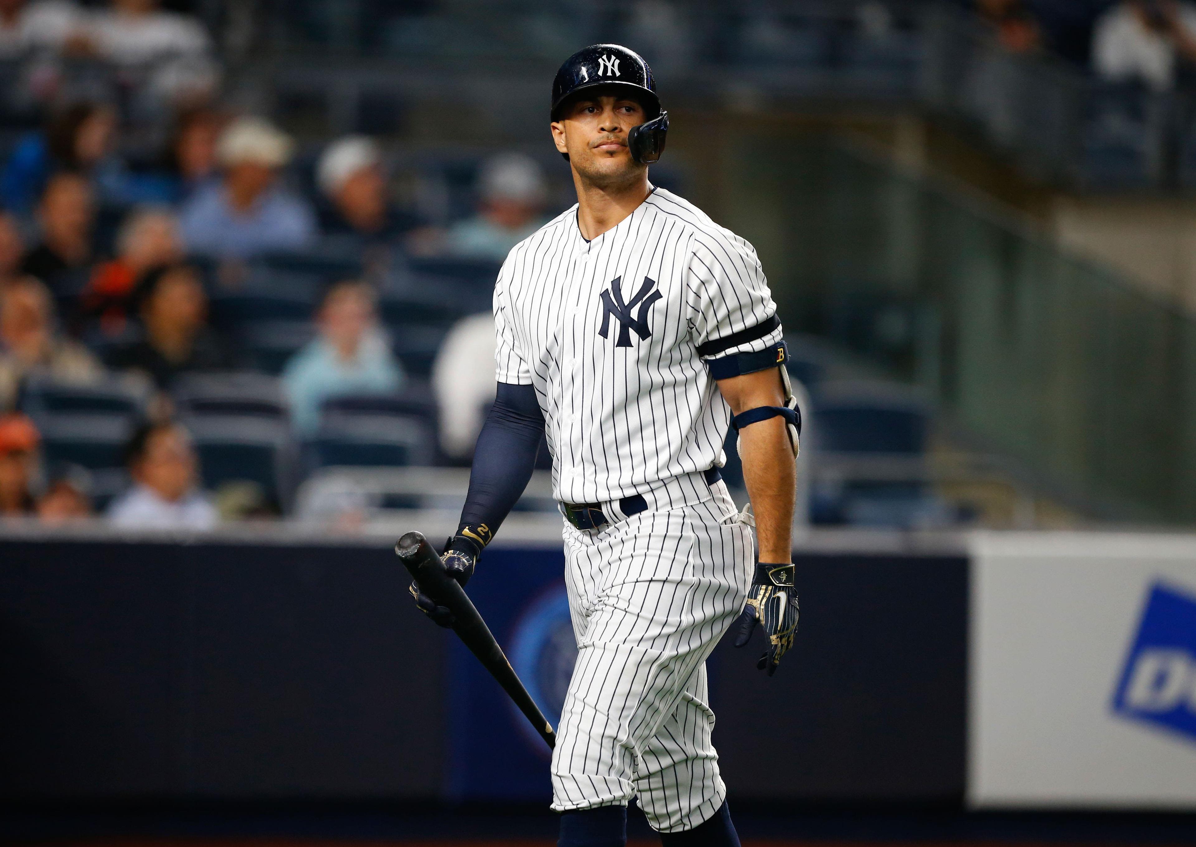 New York Yankees right fielder Giancarlo Stanton goes to the dugout after a strike out against the Houston Astros at Yankee Stadium. / Noah K. Murray/USA TODAY Sports