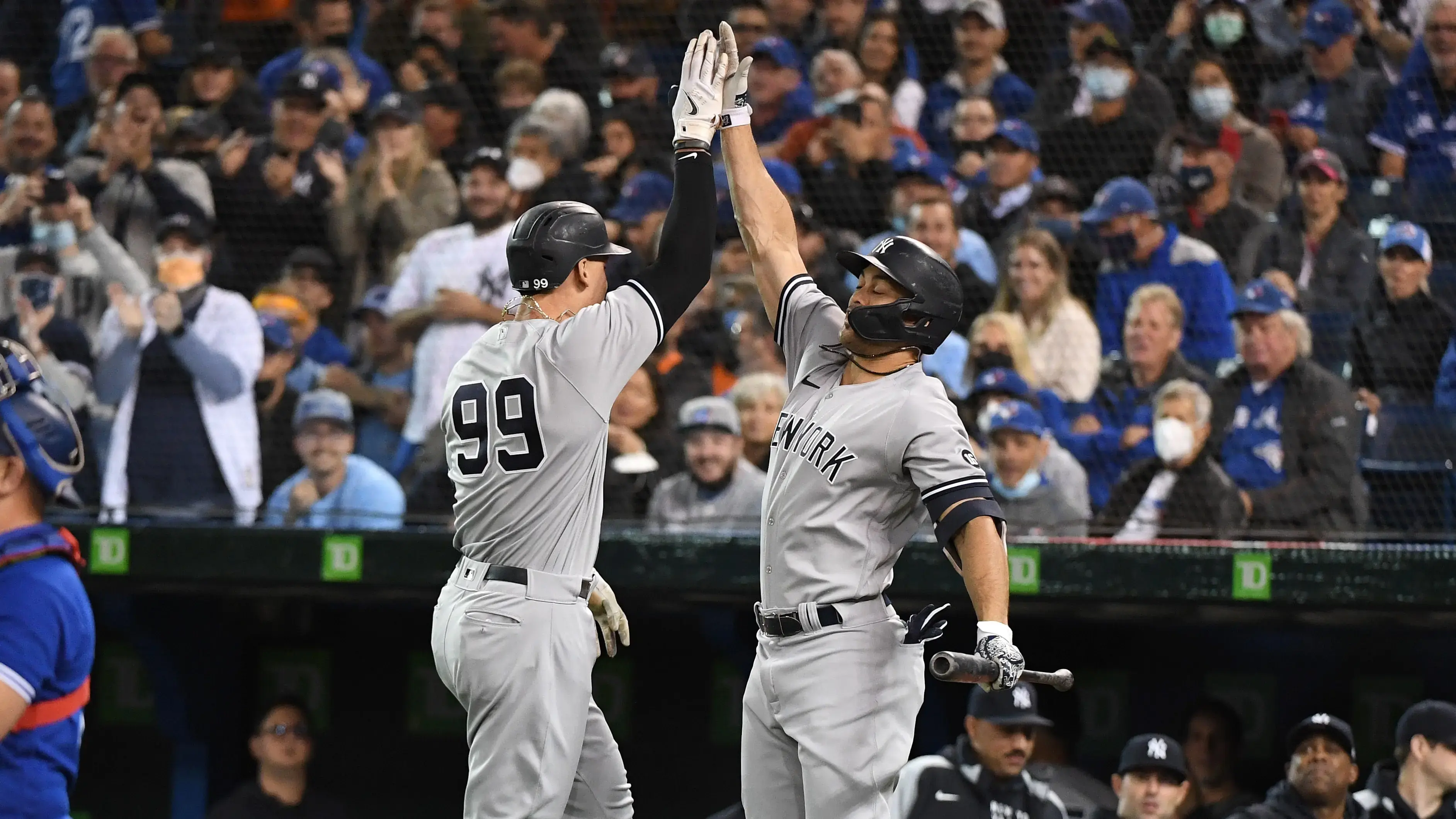 Sep 30, 2021; Toronto, Ontario, CAN; New York Yankees right fielder Aaron Judge (99) is greeted by left fielder Giancarlo Stanton (27) after hitting a solo home run against Toronto Blue Jays in the first inning at Rogers Centre. / © Dan Hamilton-USA TODAY Sports