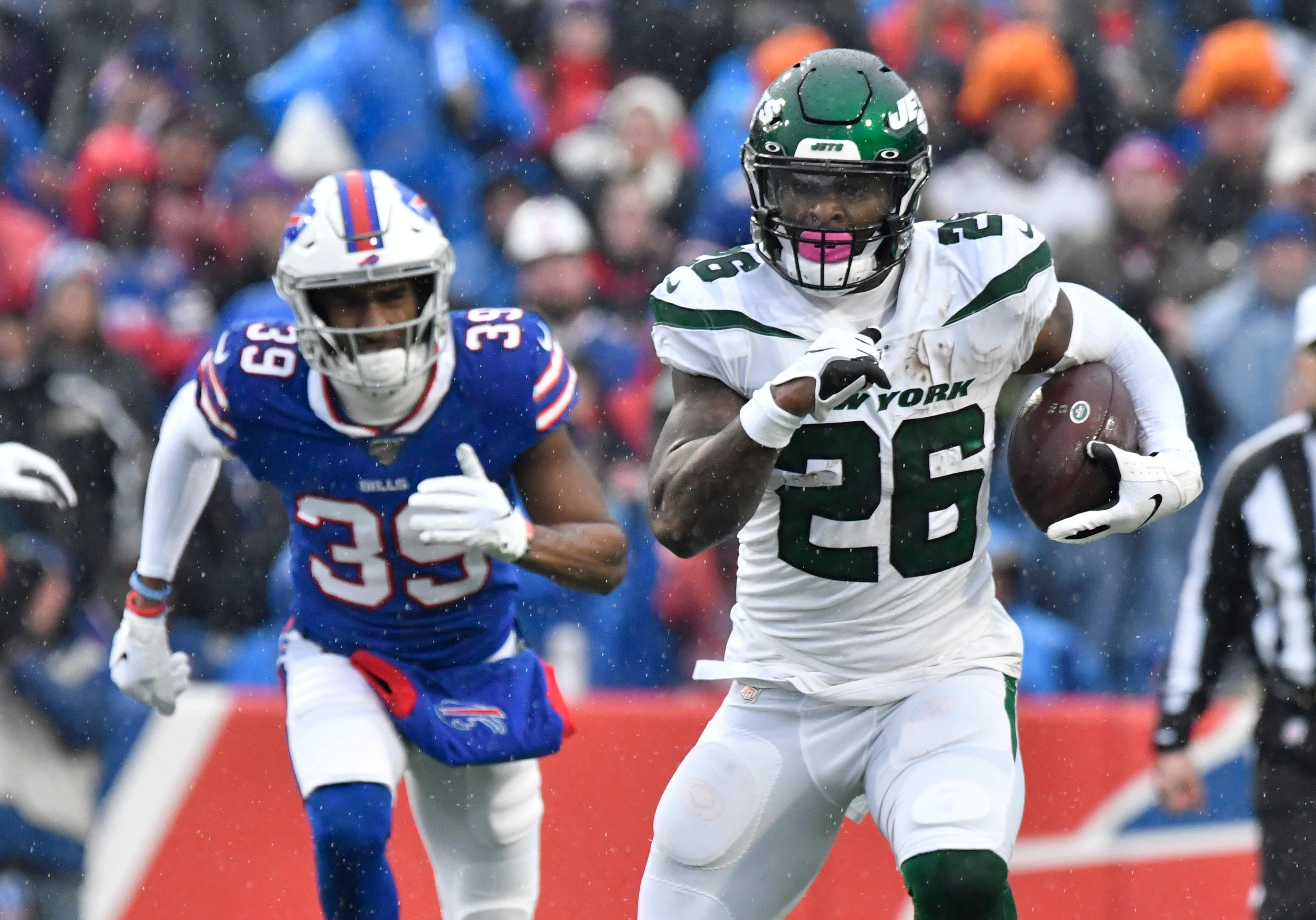 Dec 29, 2019; Orchard Park, New York, USA; New York Jets running back Le'Veon Bell (26) is chased by Buffalo Bills cornerback Levi Wallace (39) on a run in the first quarter at New Era Field. Mandatory Credit: Mark Konezny-USA TODAY Sportsundefined