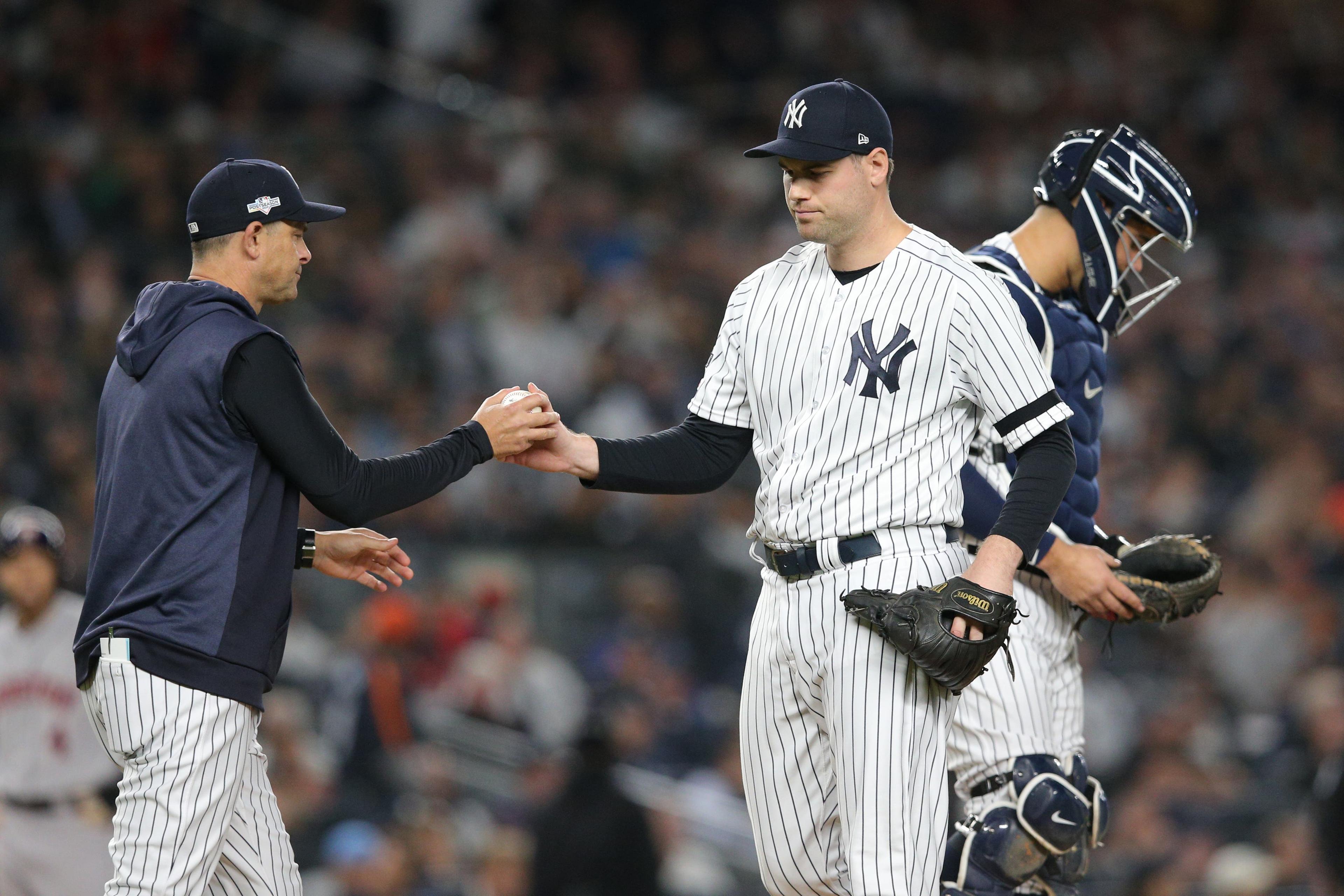 Oct 15, 2019; Bronx, NY, USA; New York Yankees relief pitcher Adam Ottavino (0) hands the ball to manager Aaron Boone (17) during the fifth inning of game three of the 2019 ALCS playoff baseball series against the Houston Astros at Yankee Stadium. Mandatory Credit: Brad Penner-USA TODAY Sports / Brad Penner