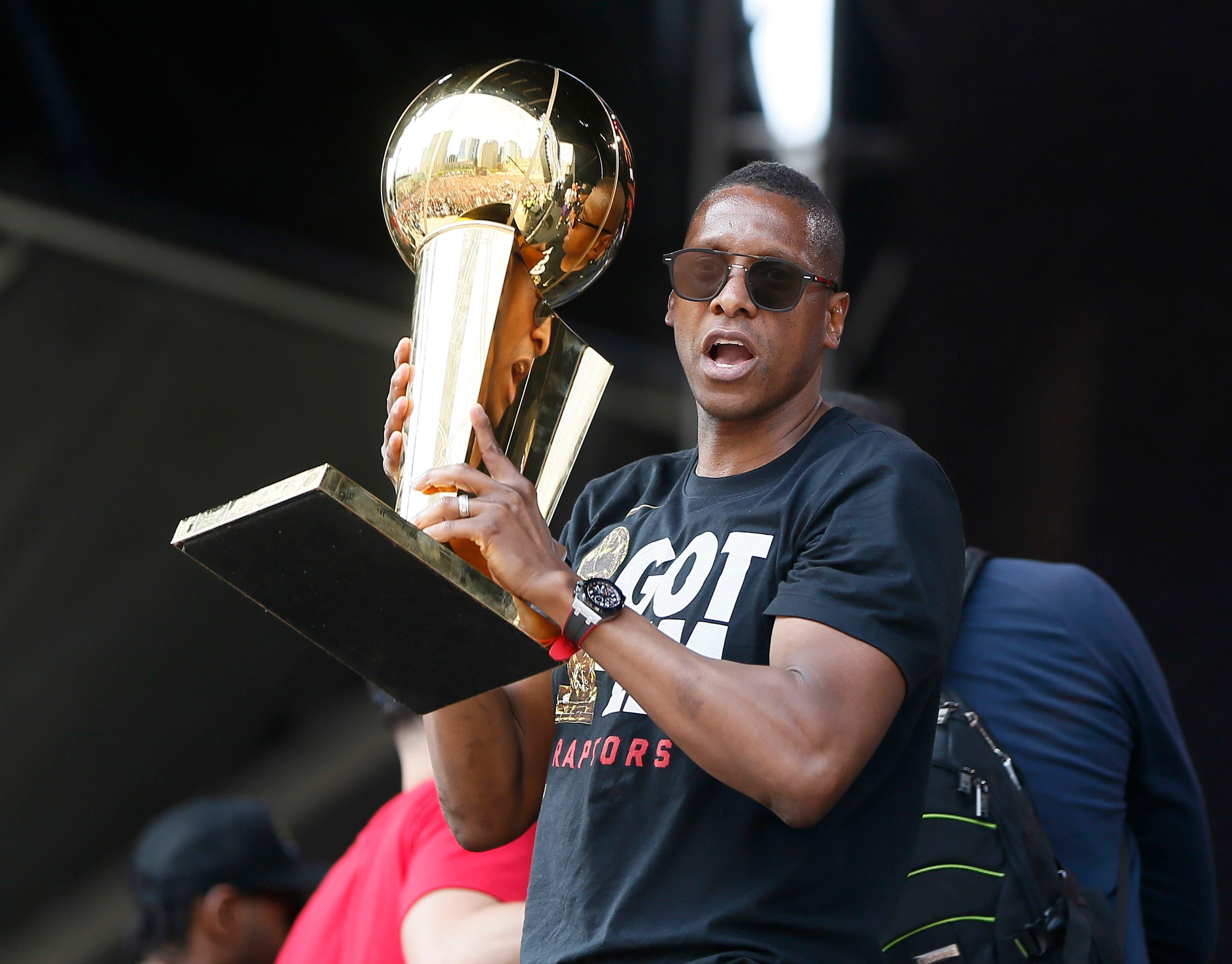 Jun 17, 2019; Toronto, Ontario, Canada; Toronto Raptors president Masai Ujiri holds up the Larry O'Brien championship trophy during a rally at Toronto city hall Nathan Phillips Square. Mandatory Credit: John E. Sokolowski-USA TODAY Sports / John E. Sokolowski