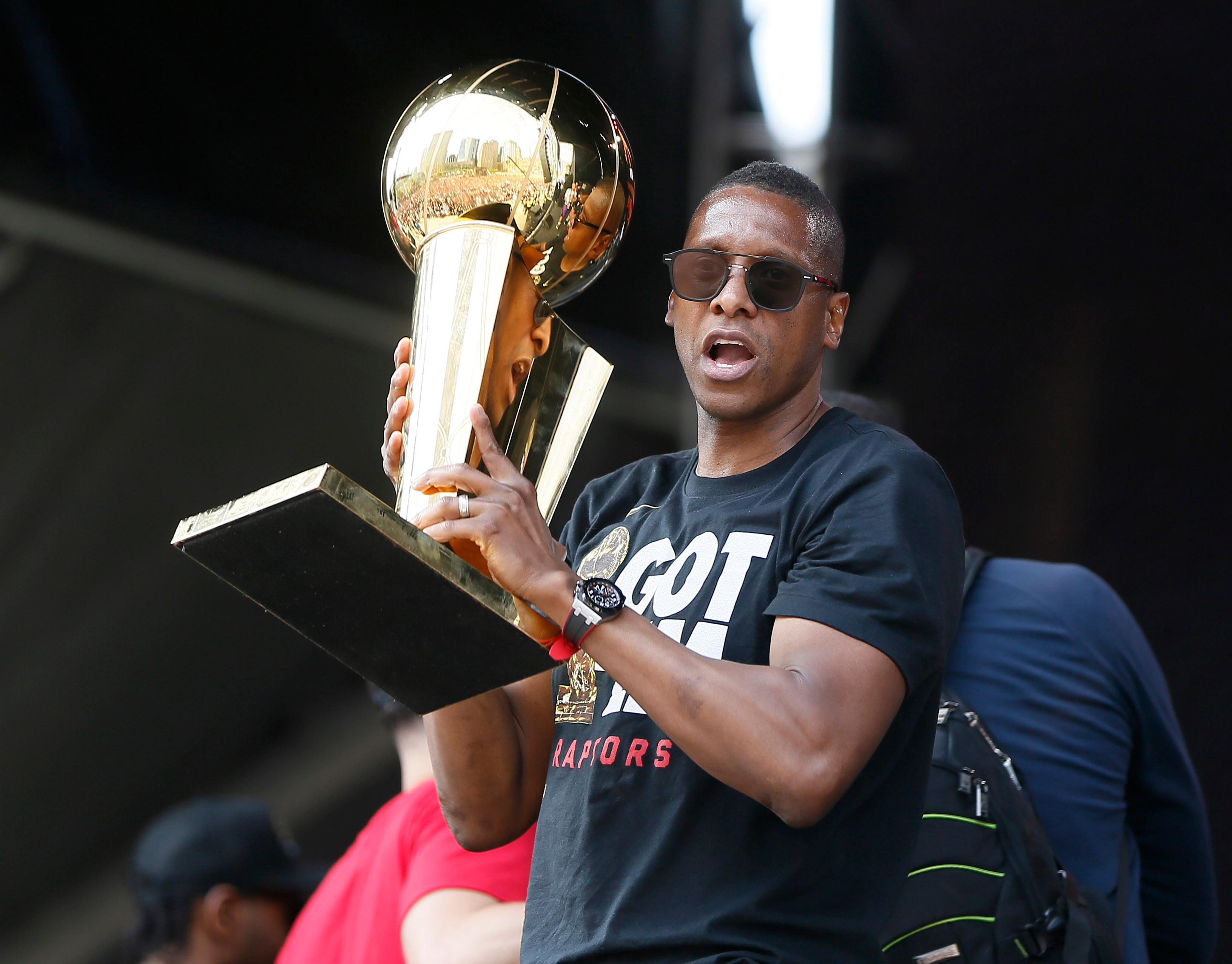 Jun 17, 2019; Toronto, Ontario, Canada; Toronto Raptors president Masai Ujiri holds up the Larry O'Brien championship trophy during a rally at Toronto city hall Nathan Phillips Square. Mandatory Credit: John E. Sokolowski-USA TODAY Sports