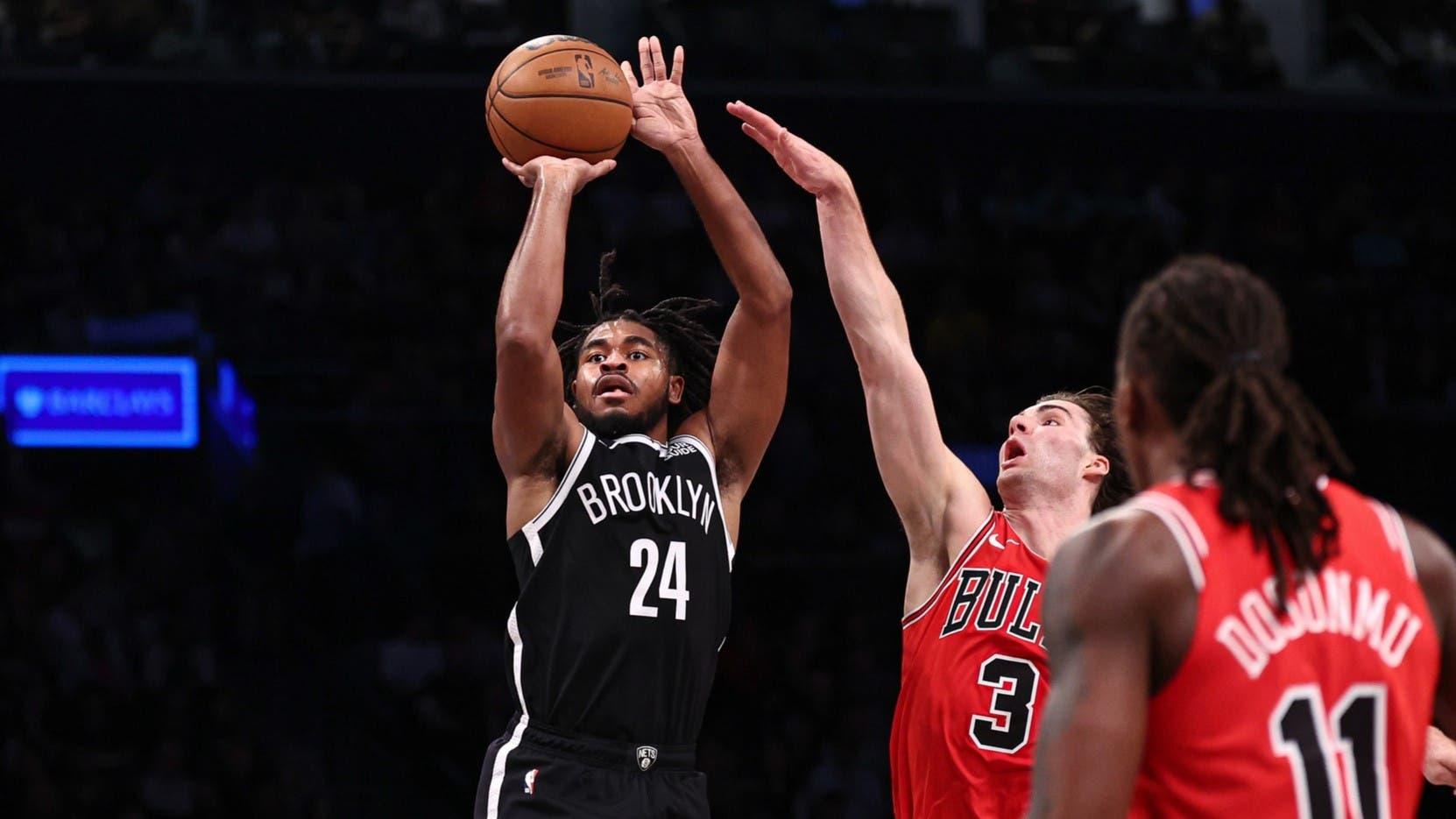 Nov 1, 2024; Brooklyn, New York, USA; Brooklyn Nets guard Cam Thomas (24) makes a three point basket during the fourth quarter as Chicago Bulls guard Josh Giddey (3) defends at Barclays Center / Vincent Carchietta-Imagn Images