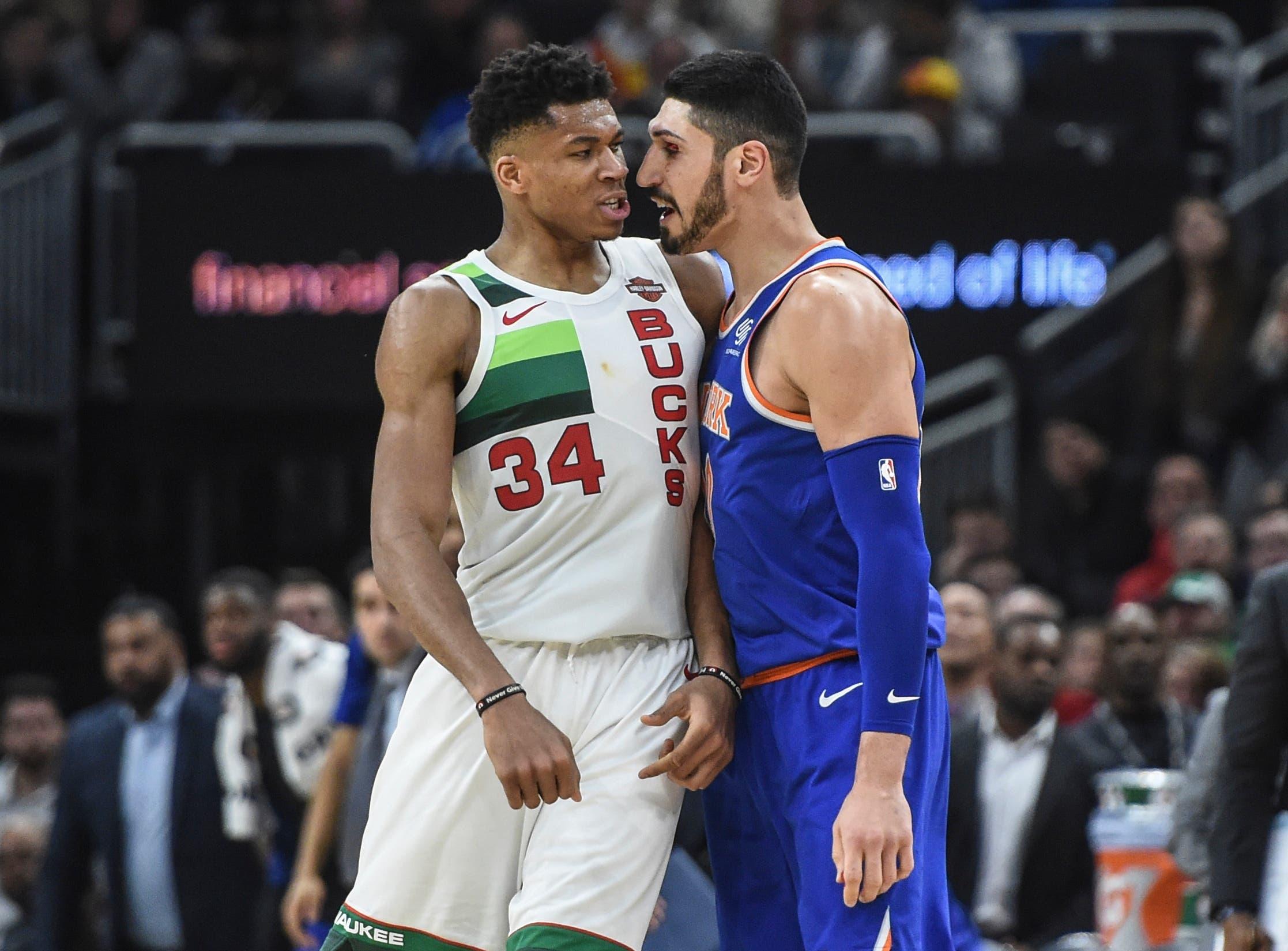 Dec 27, 2018; Milwaukee, WI, USA; Milwaukee Bucks forward Giannis Antetokounmpo (34) confronts New York Knicks center Enes Kanter (00) after a foul leading to an ejection in the fourth quarter at the Fiserv Forum. Mandatory Credit: Benny Sieu-USA TODAY Sports / Benny Sieu