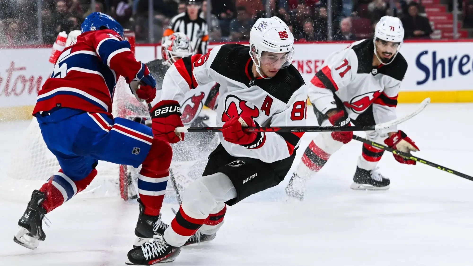 Oct 24, 2023; Montreal, Quebec, CAN; New Jersey Devils center Jack Hughes (86) plays the puck against the Montreal Canadiens during the second period at Bell Centre. / David Kirouac-USA TODAY Sports