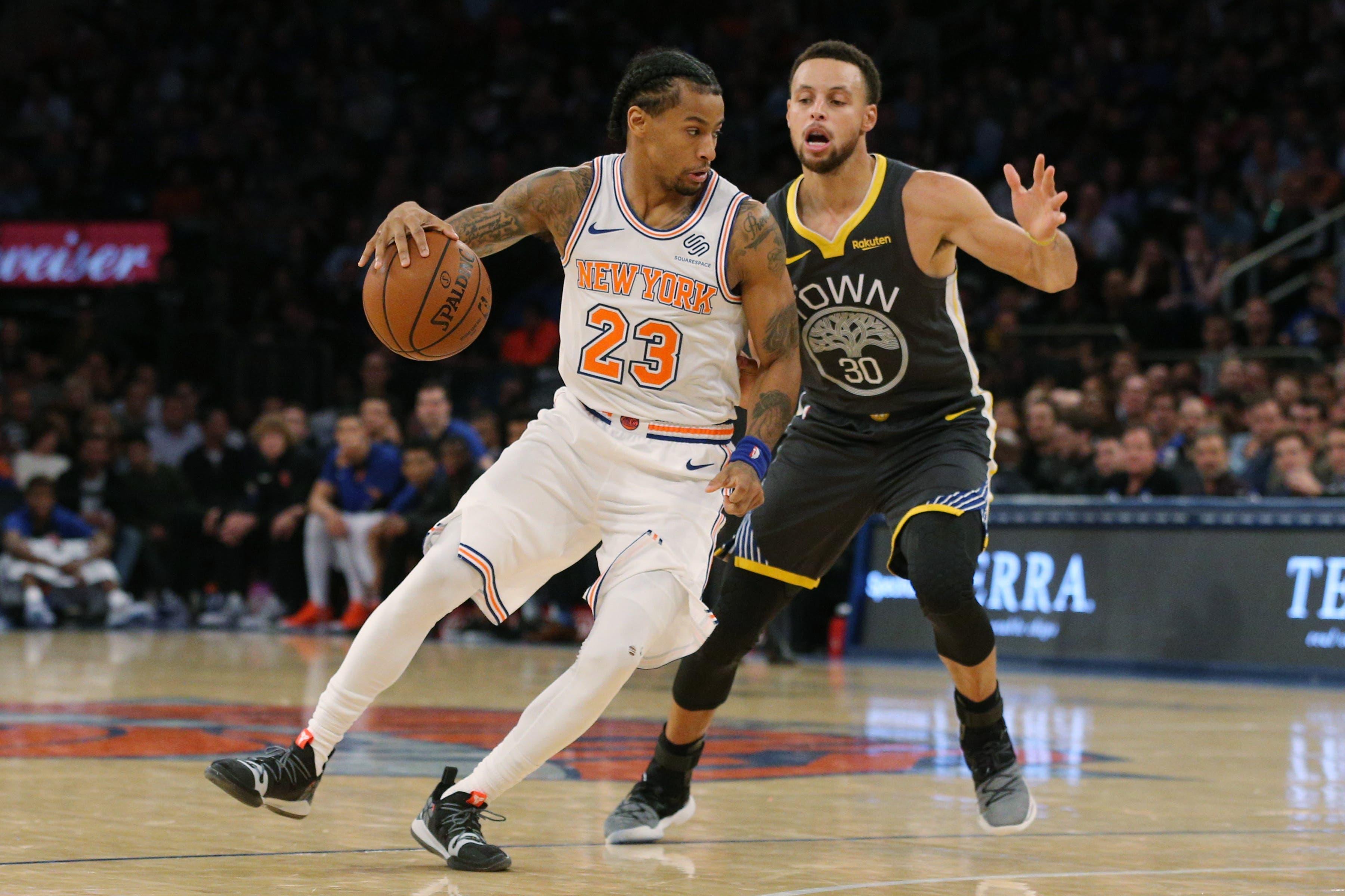 Oct 26, 2018; New York, NY, USA; New York Knicks guard Trey Burke (23) controls the ball against Golden State Warriors guard Stephen Curry (30) during the third quarter at Madison Square Garden. Mandatory Credit: Brad Penner-USA TODAY Sports / Brad Penner