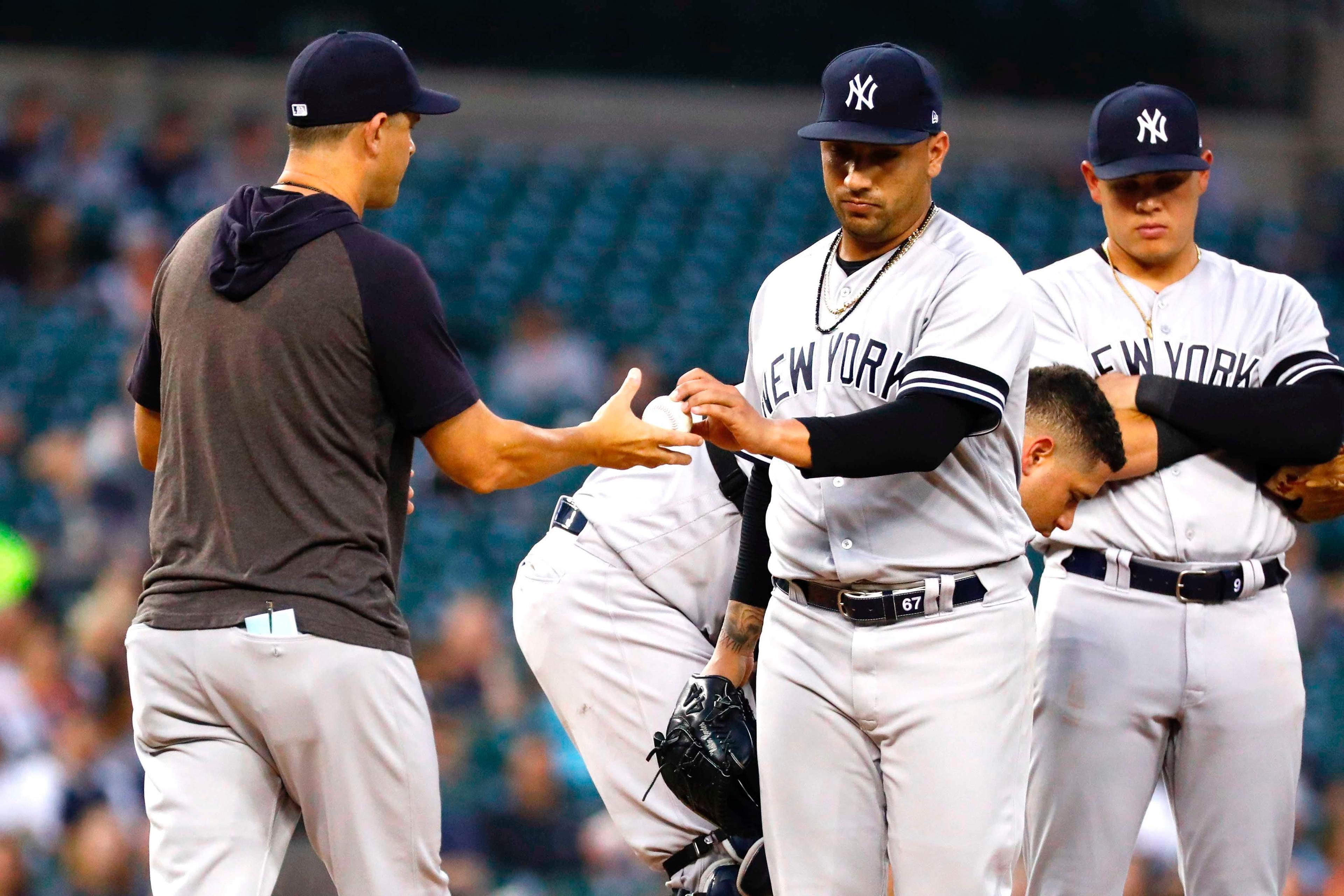 Sep 10, 2019; Detroit, MI, USA; New York Yankees manager Aaron Boone (17) take the ball to relieve relief pitcher Nestor Cortes Jr. (67) in the third inning against the Detroit Tigers at Comerica Park. Mandatory Credit: Rick Osentoski-USA TODAY Sports / Rick Osentoski