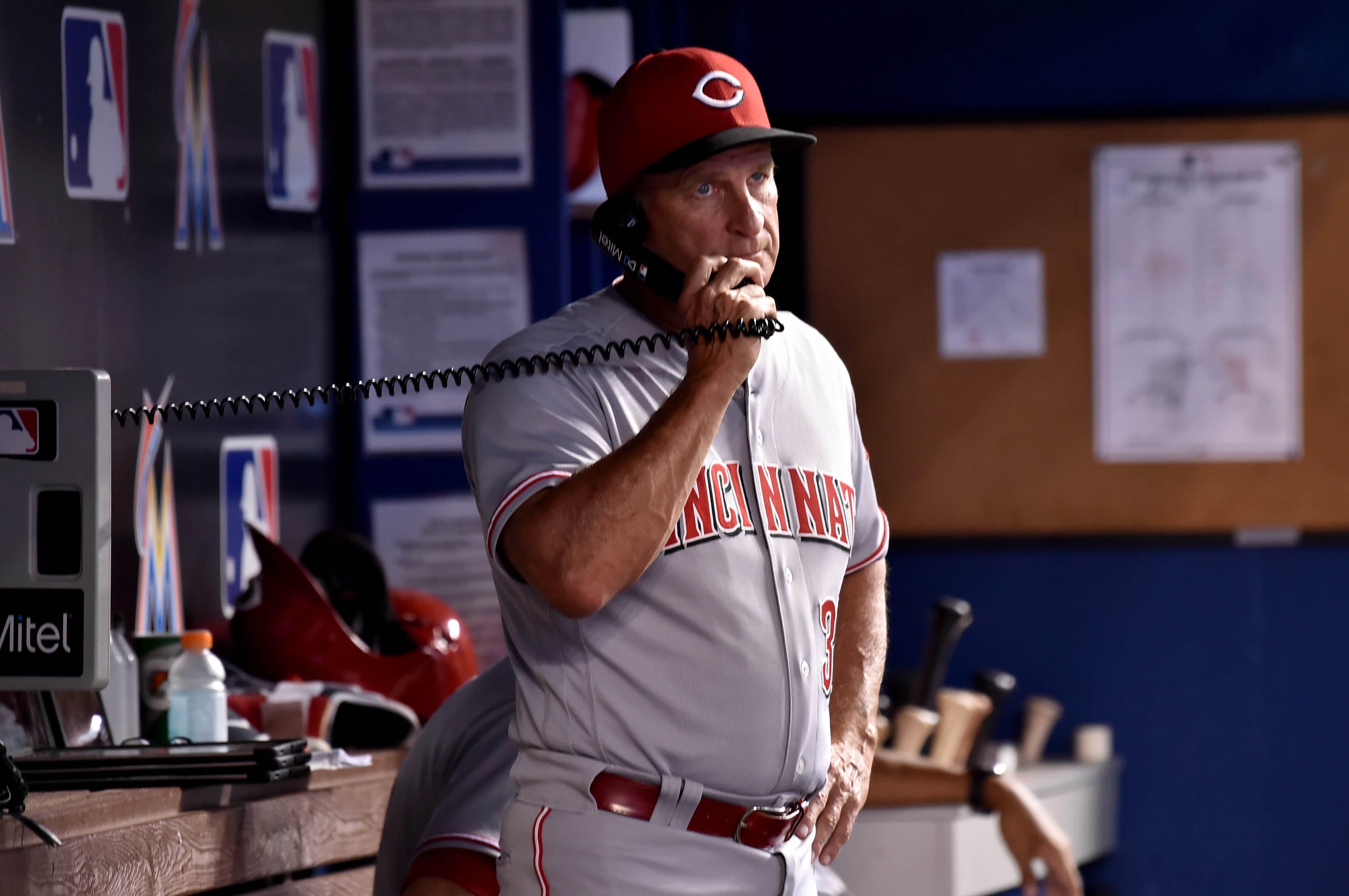 Cincinnati Reds interim manager Jim Riggleman uses the telephone during the first inning against the Miami Marlins at Marlins Park. / Steve Mitchell/USA TODAY Sports