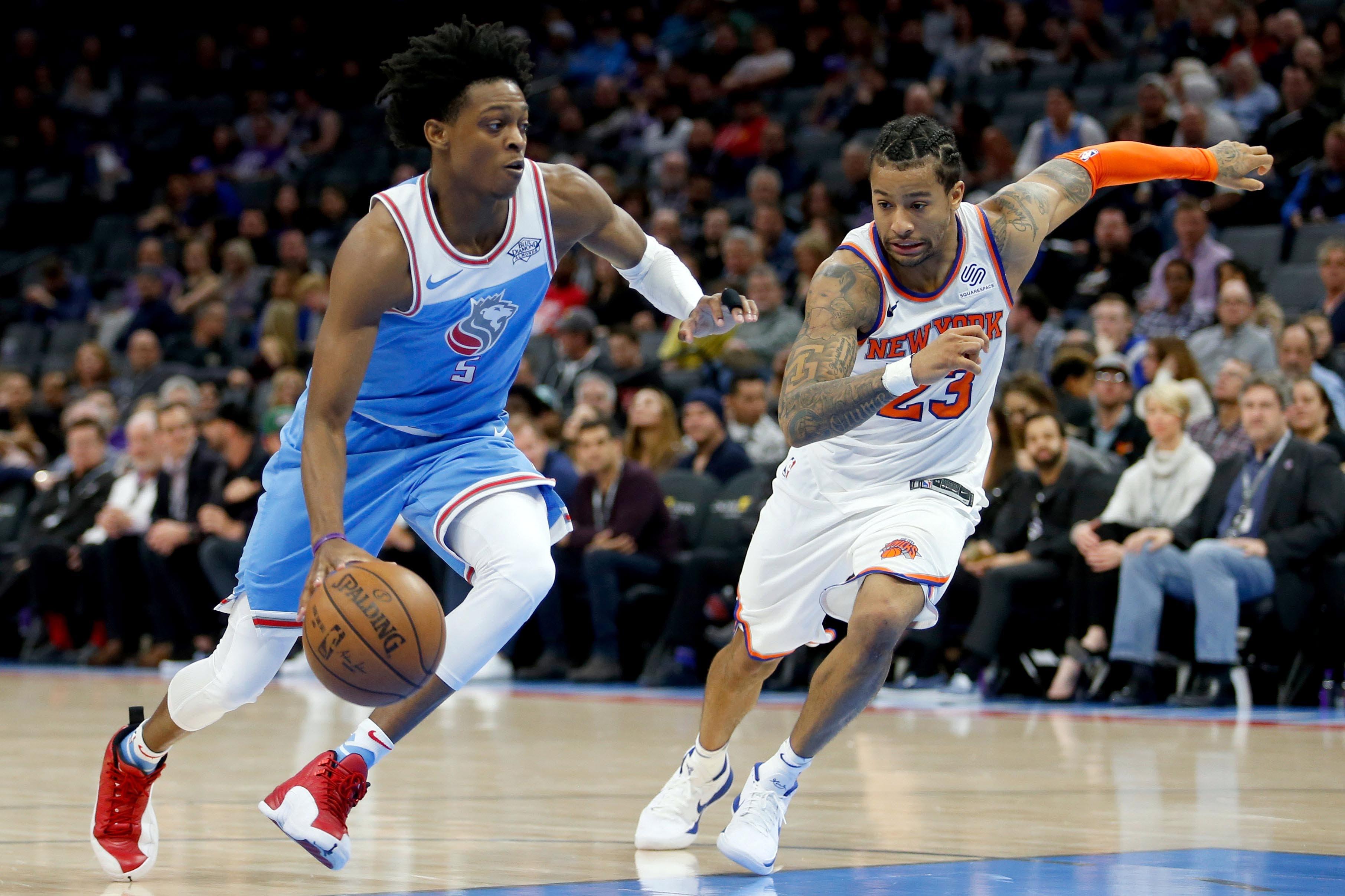 Mar 4, 2018; Sacramento, CA, USA; Sacramento Kings guard De'Aron Fox (5) drives the ball against New York Knicks guard Trey Burke (23) in the fourth quarter at Golden 1 Center. Mandatory Credit: Kiel Maddox-USA TODAY Sports / Kiel Maddox