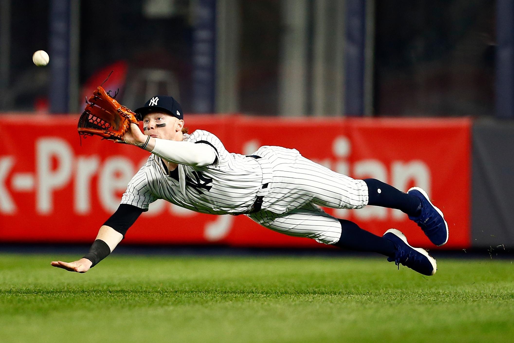 New York Yankees left fielder Clint Frazier attempts a diving catch on a hit by Seattle Mariners catcher Omar Narvaez during the eighth inning at Yankee Stadium.