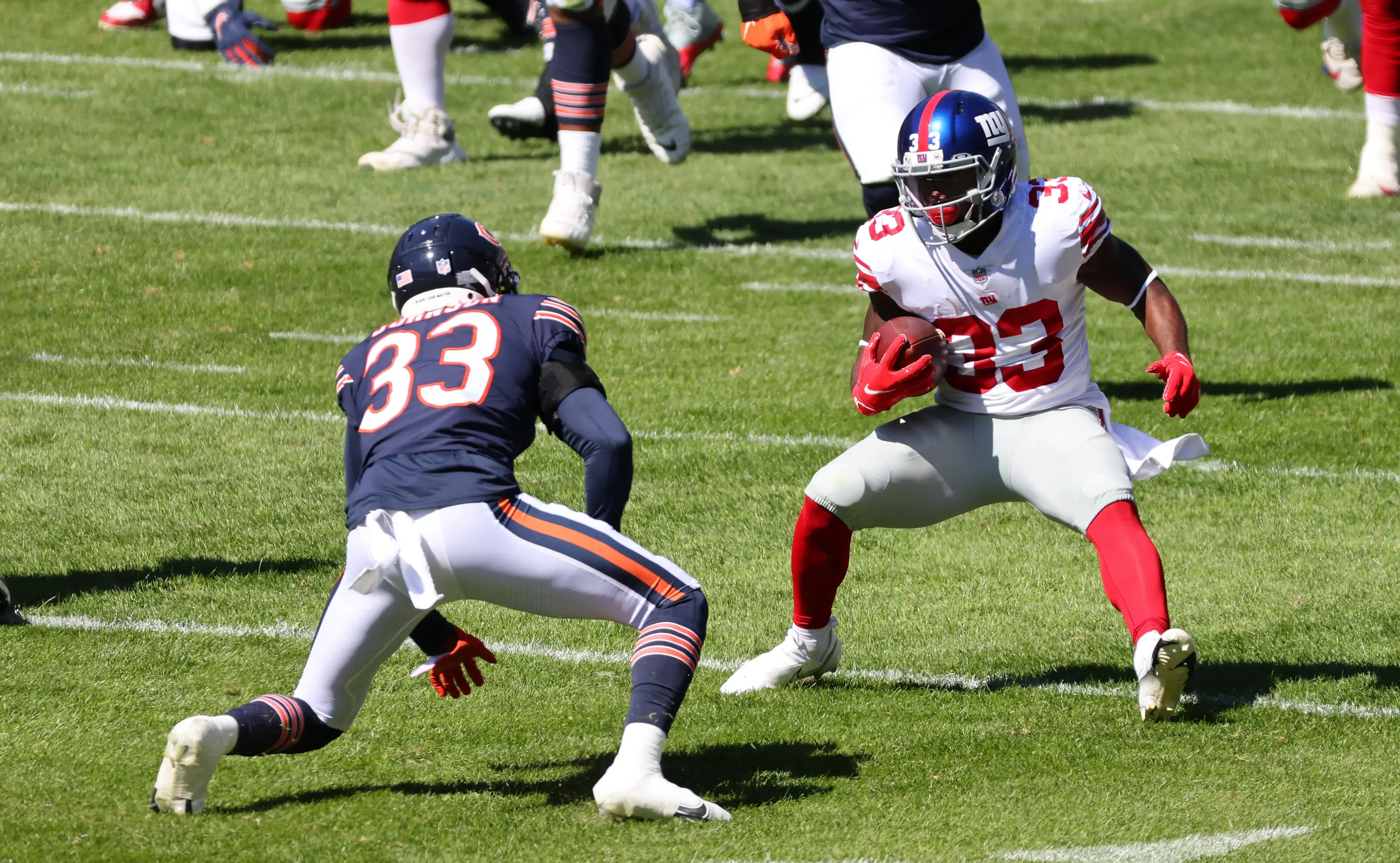 Sep 20, 2020; Chicago, Illinois, USA; New York Giants running back Dion Lewis (33) rushes the ball against Chicago Bears cornerback Jaylon Johnson (33) during the second quarter at Soldier Field. Mandatory Credit: Mike Dinovo-USA TODAY Sports / © Mike Dinovo-USA TODAY Sports