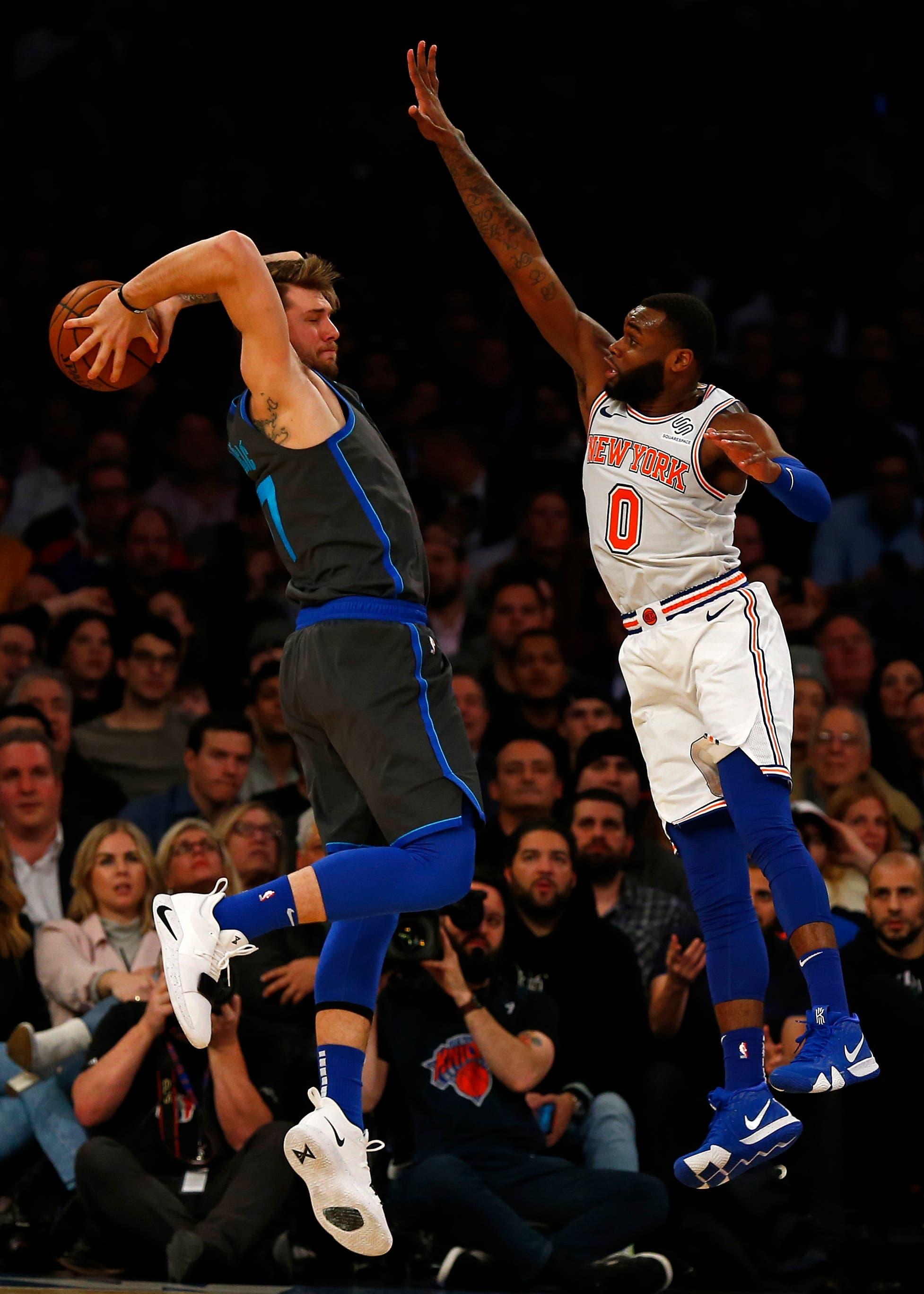 Dallas Mavericks forward Luka Doncic looks to pass around New York Knicks guard Kadeem Allen during the second half at Madison Square Garden. / Adam Hunger/USA TODAY Sports