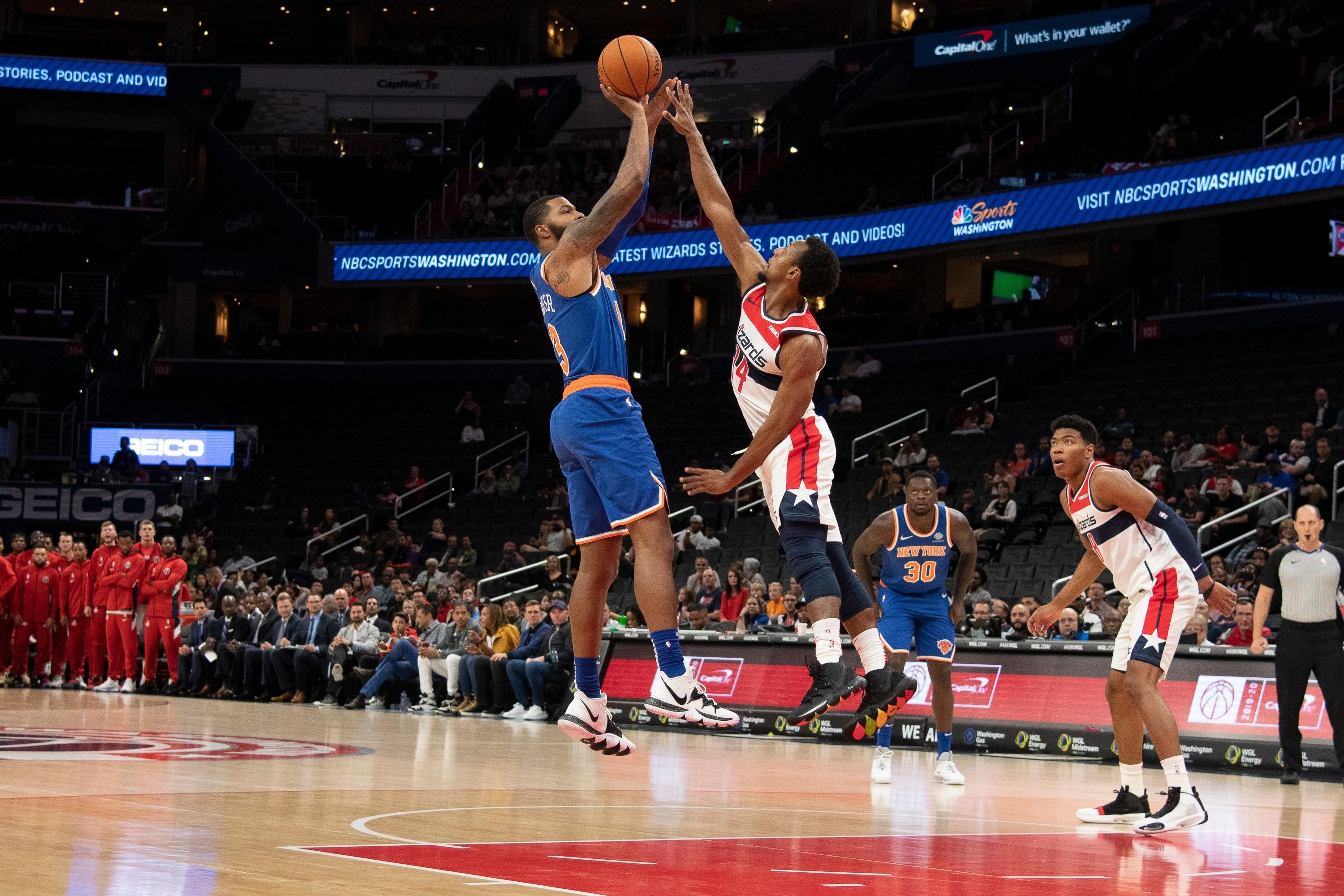 Oct 7, 2019; Washington, DC, USA; New York Knicks forward Marcus Morris (13) shoots over Washington Wizards guard Ish Smith (14) during the first half at Capital One Arena. Mandatory Credit: Tommy Gilligan-USA TODAY Sports