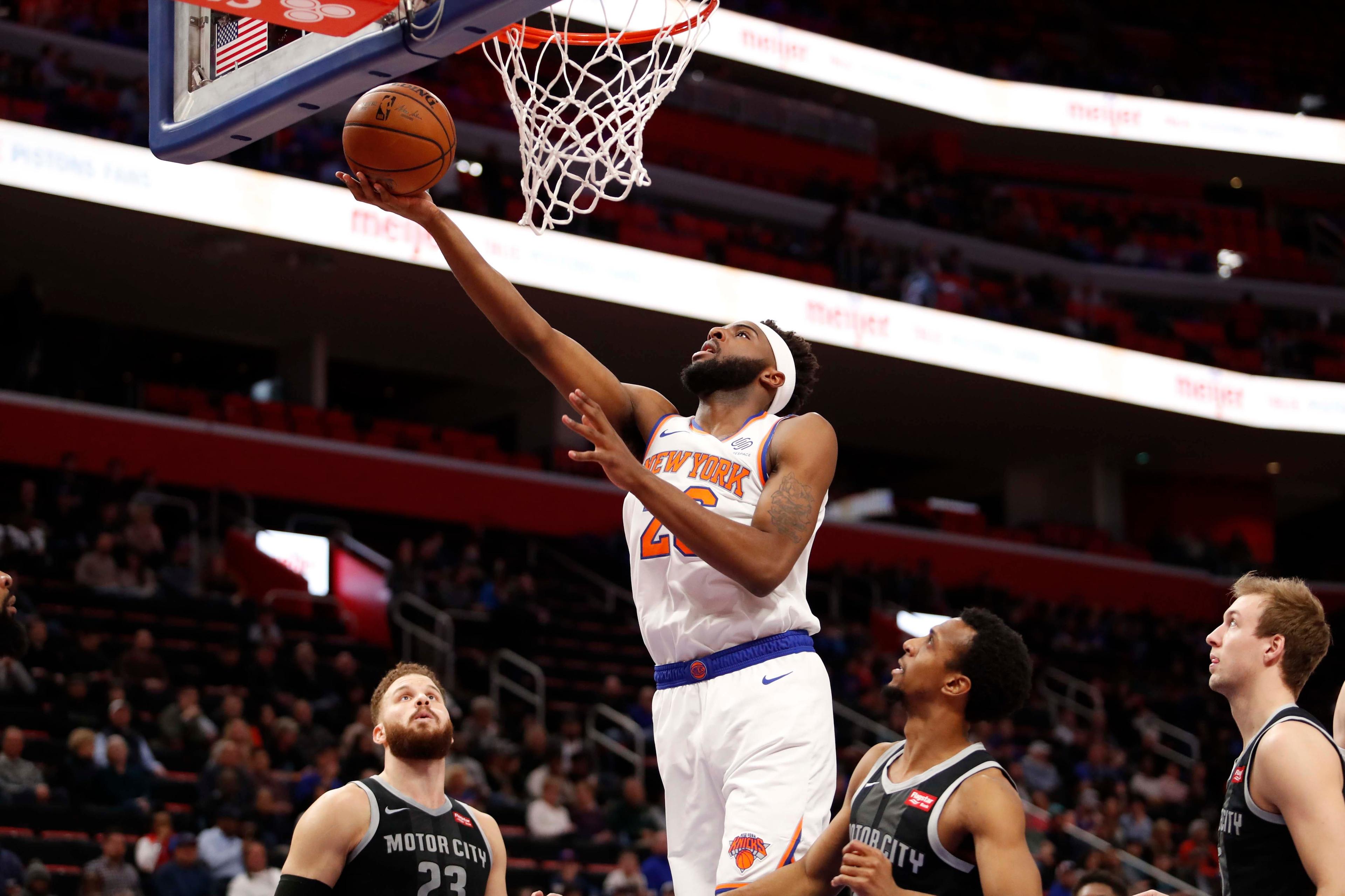 Feb 8, 2019; Detroit, MI, USA; New York Knicks center Mitchell Robinson (26) goes up for a shot against Detroit Pistons forward Blake Griffin (23) and guard Ish Smith (14) during the first quarter at Little Caesars Arena. Mandatory Credit: Raj Mehta-USA TODAY Sports / Raj Mehta