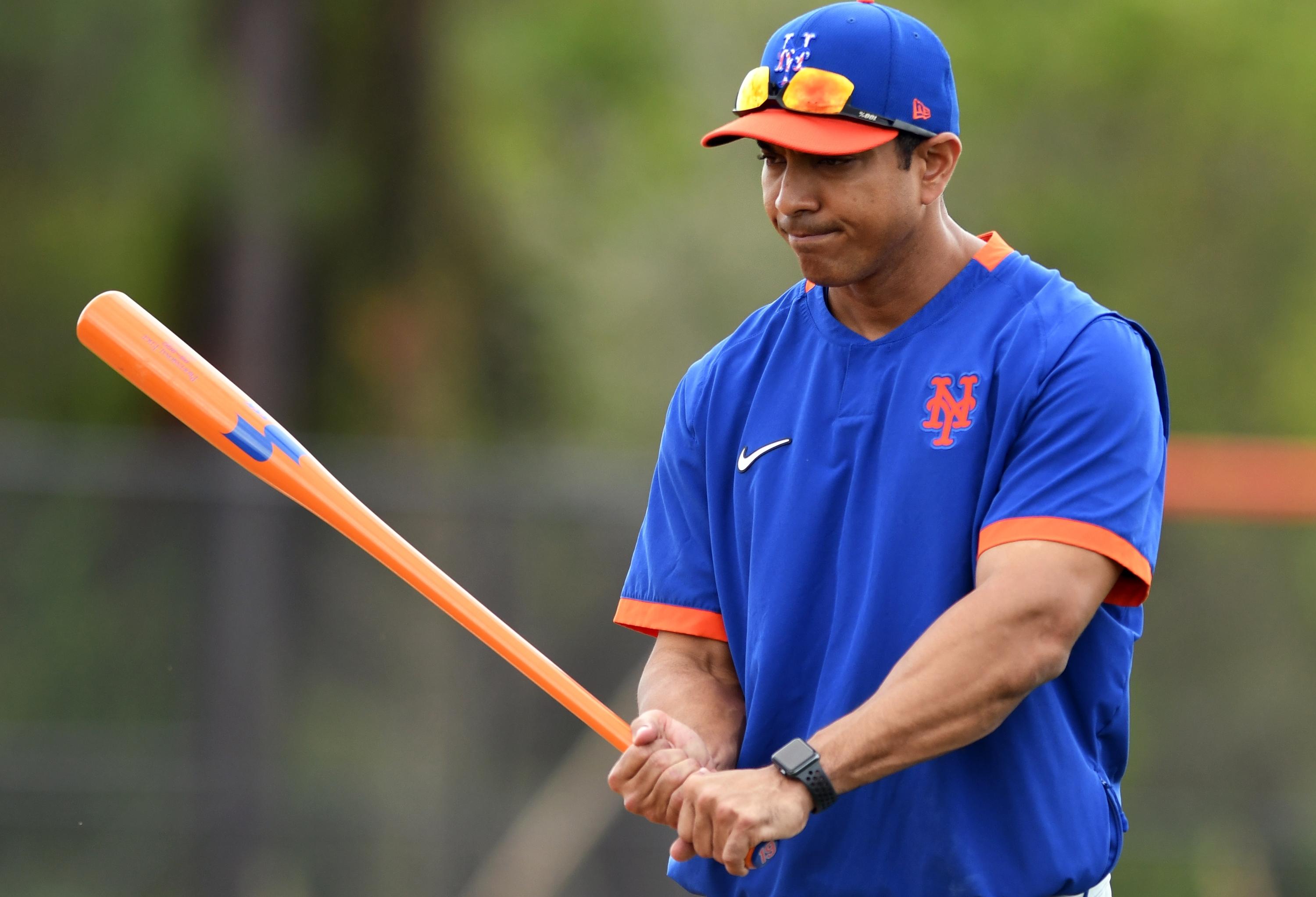 Feb 18, 2020; Port St. Lucie, Florida, USA; New York Mets manager Luis Rojas swings a bat between workout stations at spring training. Mandatory Credit: Jim Rassol-USA TODAY Sports