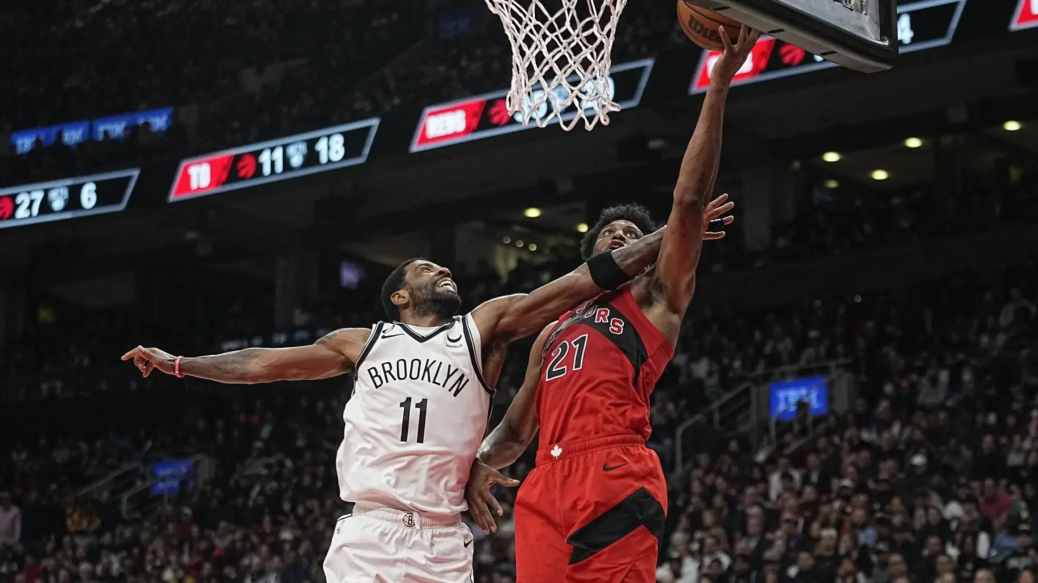 Nov 23, 2022; Toronto, Ontario, CAN; Brooklyn Nets guard Kyrie Irving (11) defends against Toronto Raptors forward Thaddeus Young (21) during the second half at Scotiabank Arena. / John E. Sokolowski-USA TODAY Sports