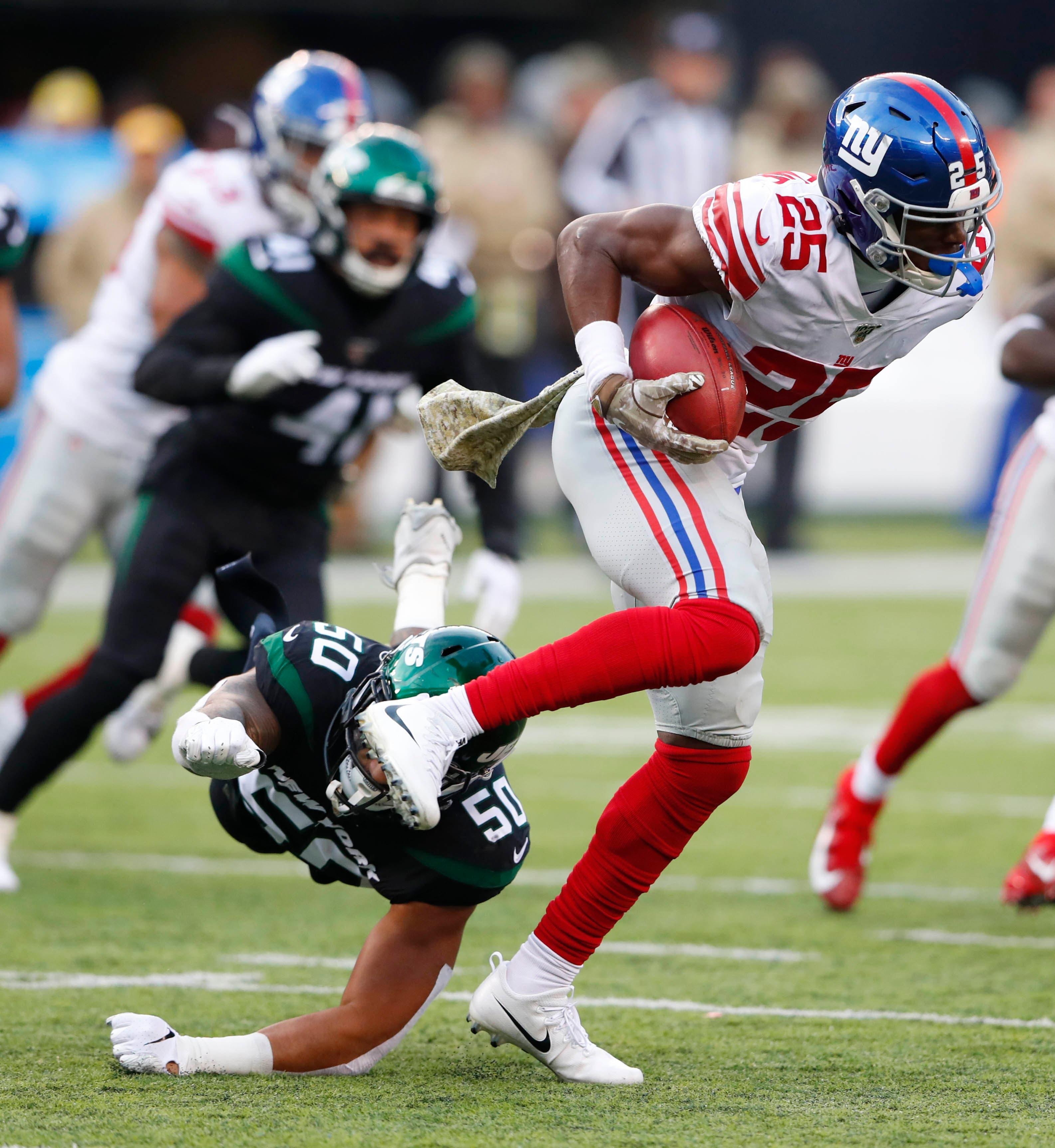 Nov 10, 2019; East Rutherford, NJ, USA; New York Giants defensive back Corey Ballentine (25) avoids the tackle of New York Jets linebacker Frankie Luvu (50) during the second half at MetLife Stadium. Mandatory Credit: Noah K. Murray-USA TODAY Sports / Noah K. Murray