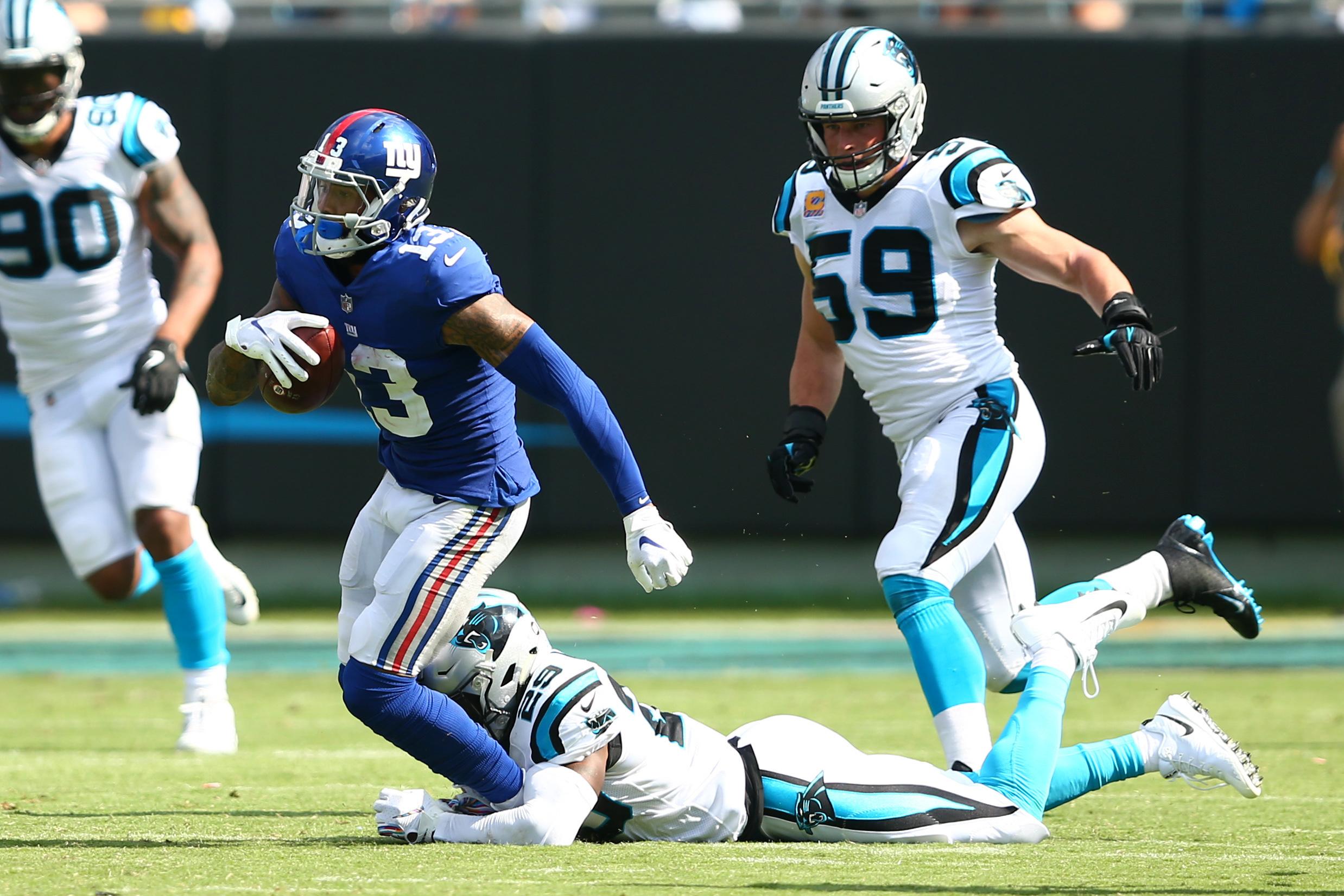 Oct 7, 2018; Charlotte, NC, USA; New York Giants wide receiver Odell Beckham (13) carries the ball past Carolina Panthers free safety Mike Adams (29) in the third quarter at Bank of America Stadium. Mandatory Credit: Jeremy Brevard-USA TODAY Sports 