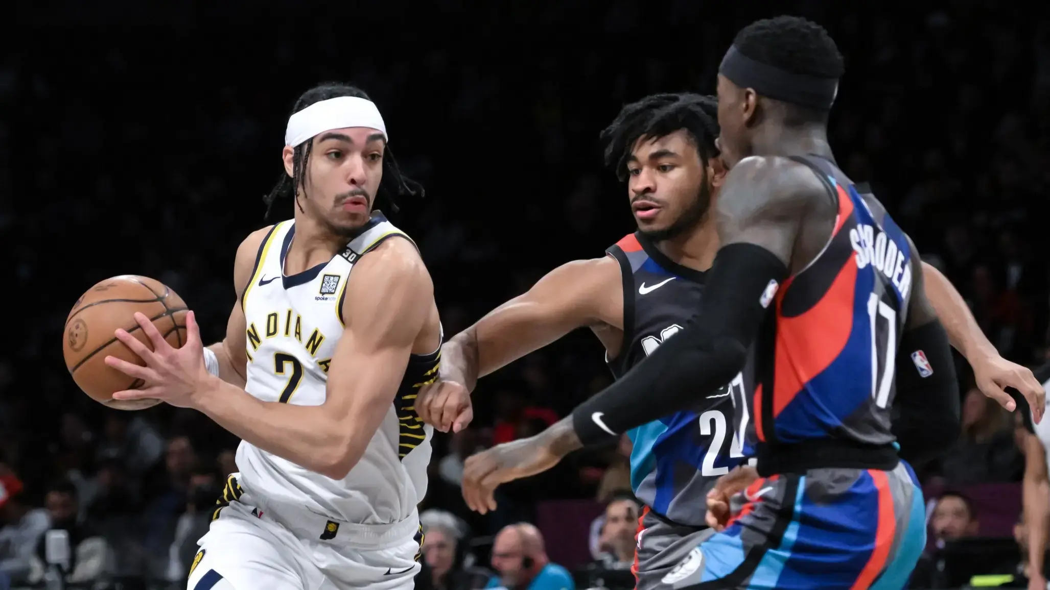 Apr 3, 2024; Brooklyn, New York, USA; Indiana Pacers guard Andrew Nembhard (2) drives to the basket while being defended by Brooklyn Nets guard Cam Thomas (24) and Brooklyn Nets guard Dennis Schroder (17) during the first quarter at Barclays Center. / John Jones-USA TODAY Sports