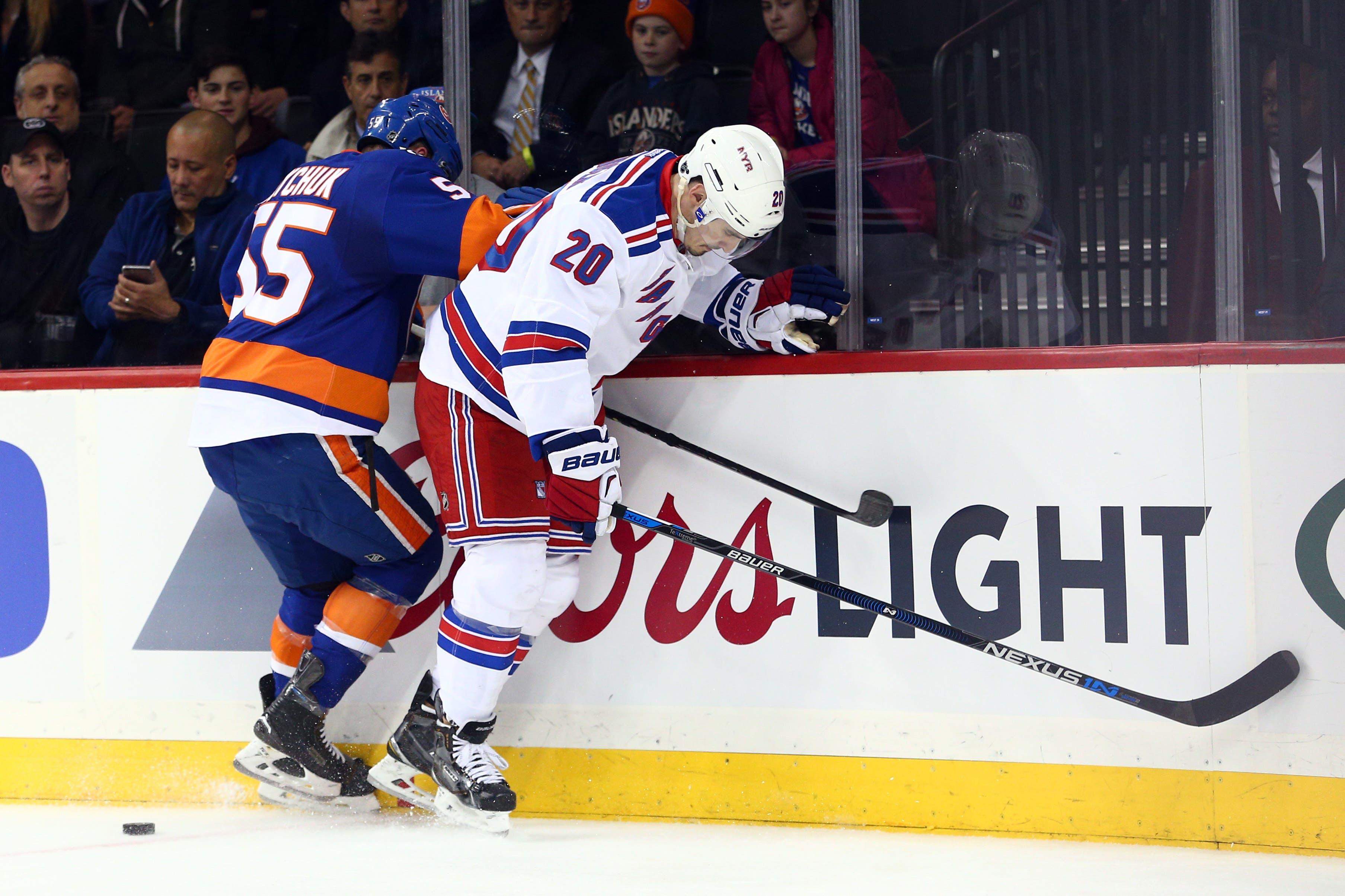 New York Rangers left wing Chris Kreider (20) and New York Islanders defenseman Johnny Boychuk (55) fight for the puck during the first period at Barclays Center. / Brad Penner