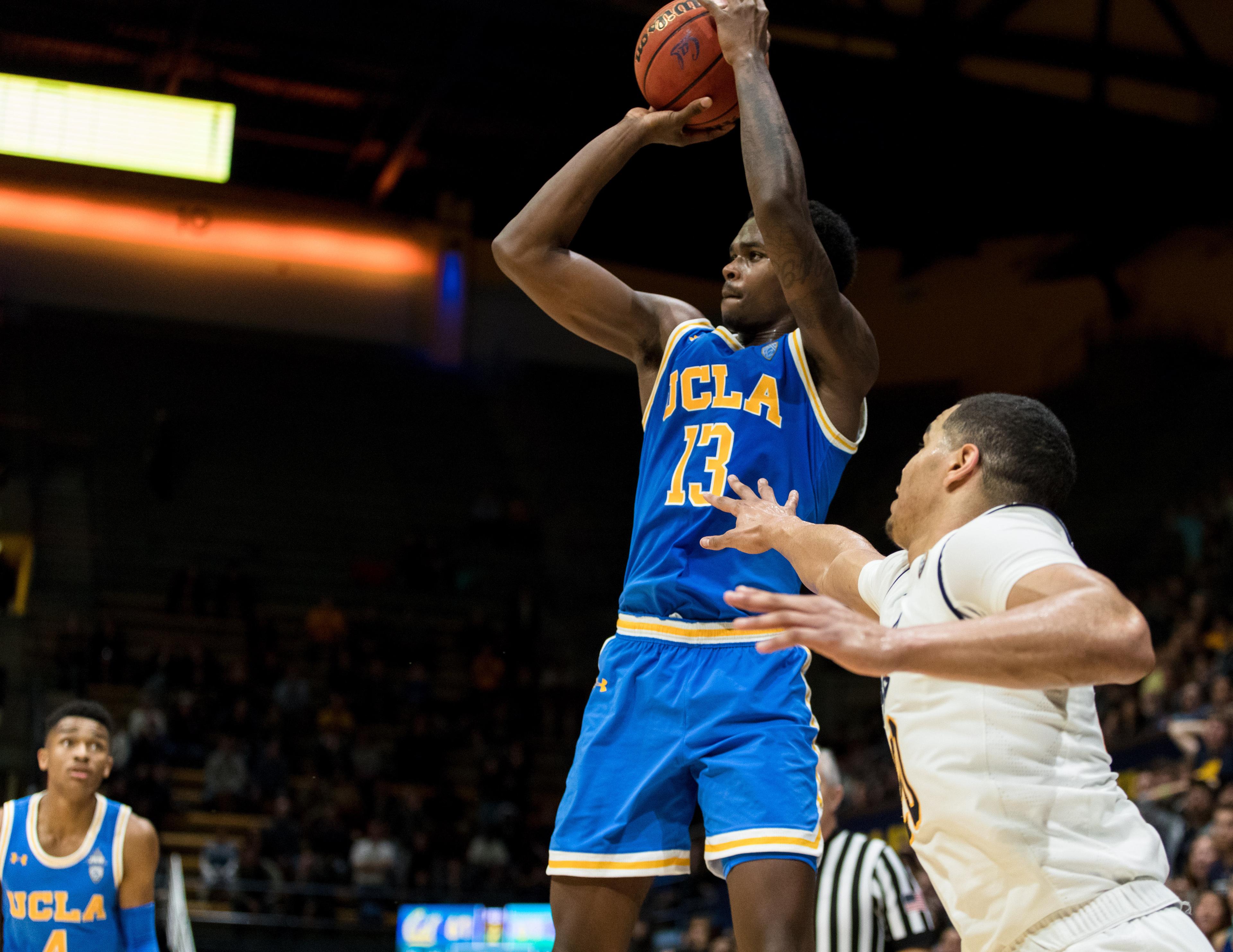 Feb 13, 2019; Berkeley, CA, USA; UCLA Bruins guard Kris Wilkes (13) takes a three-point shot as California Golden Bears guard Matt Bradley (20) defends in the second half at Haas Pavilion. Mandatory Credit: John Hefti-USA TODAY Sports