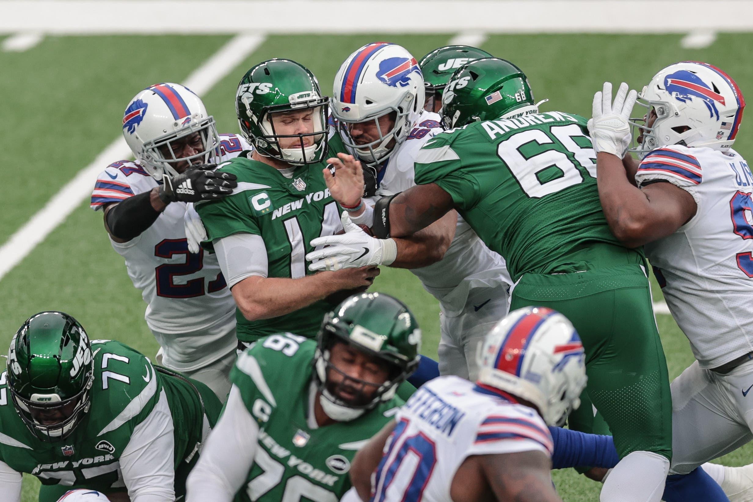 Oct 25, 2020; East Rutherford, New Jersey, USA; New York Jets quarterback Sam Darnold (14) is sacked by outside linebacker Matt Milano (58) and cornerback Tre'Davious White (27) during the second half at MetLife Stadium. / © Vincent Carchietta-USA TODAY Sports