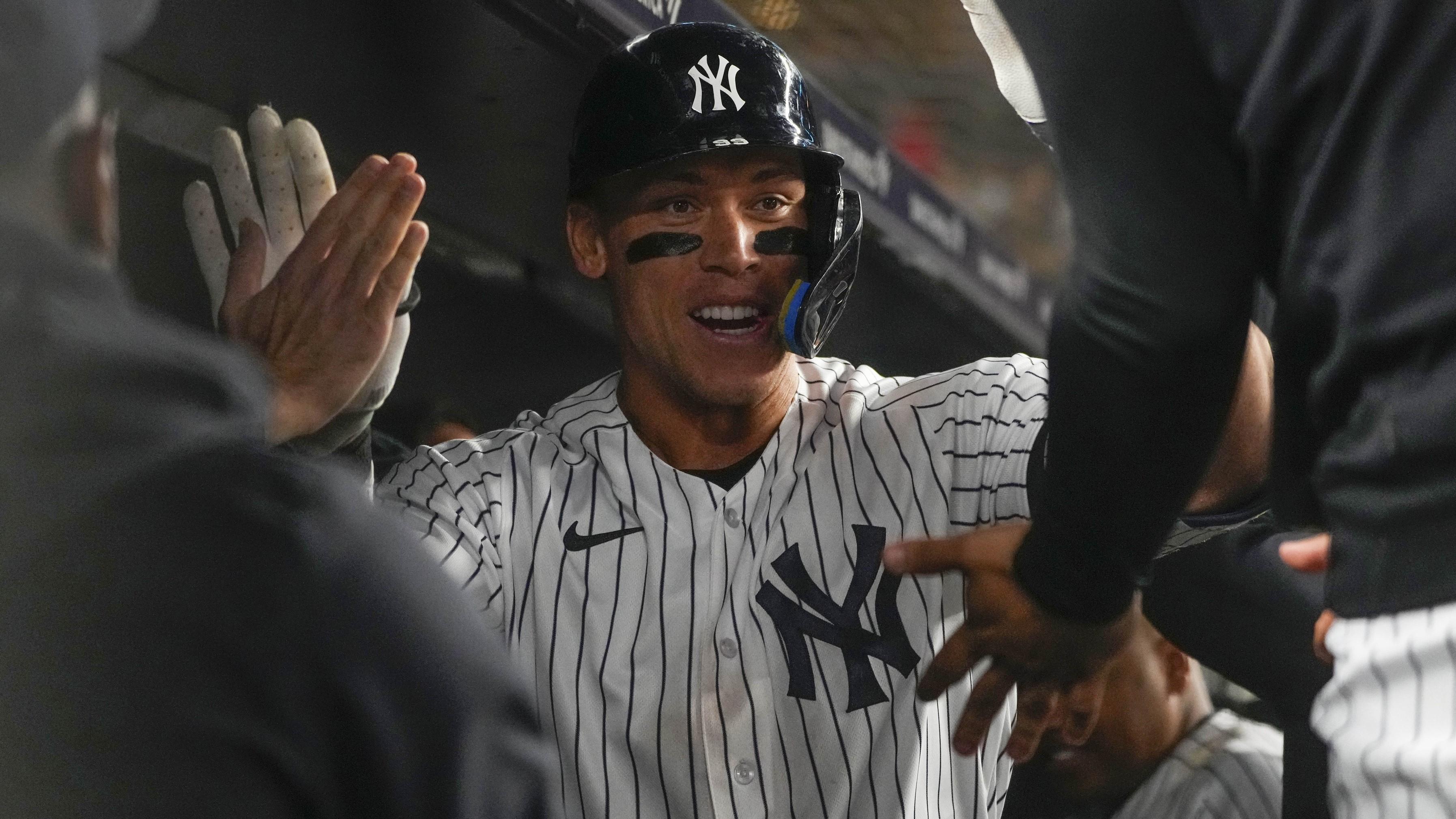 May 23, 2023; Bronx, New York, USA; New York Yankees right fielder Aaron Judge (99) is congratulated by teammates for hitting a home run against the Baltimore Orioles during the ninth inning at Yankee Stadium. / Gregory Fisher-USA TODAY Sports