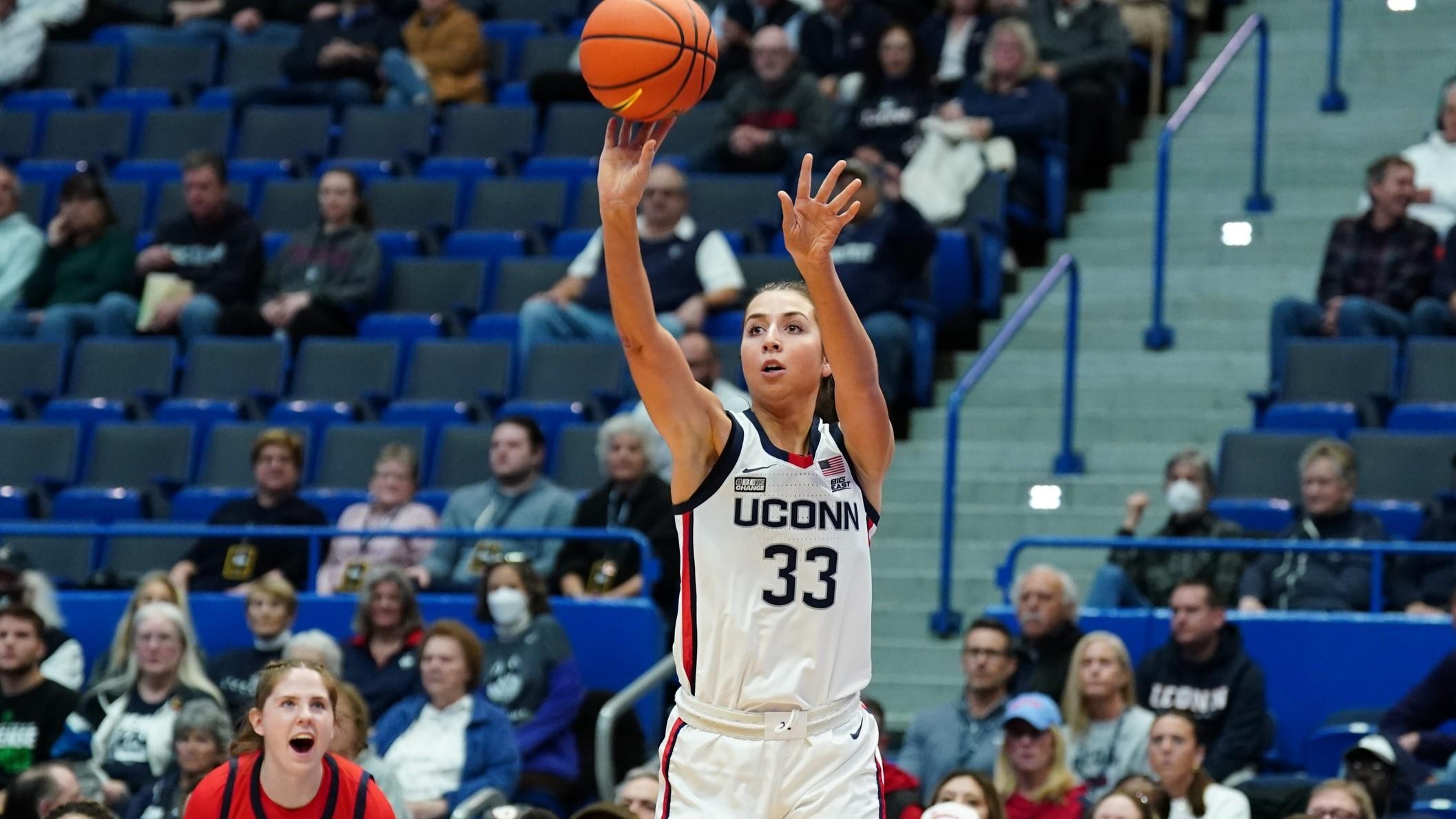 Nov 8, 2023; Hartford, Connecticut, USA; UConn Huskies guard Caroline Ducharme (33) shoots for three points against the Dayton Flyers in the first half at XL Center. / David Butler II-USA TODAY Sports