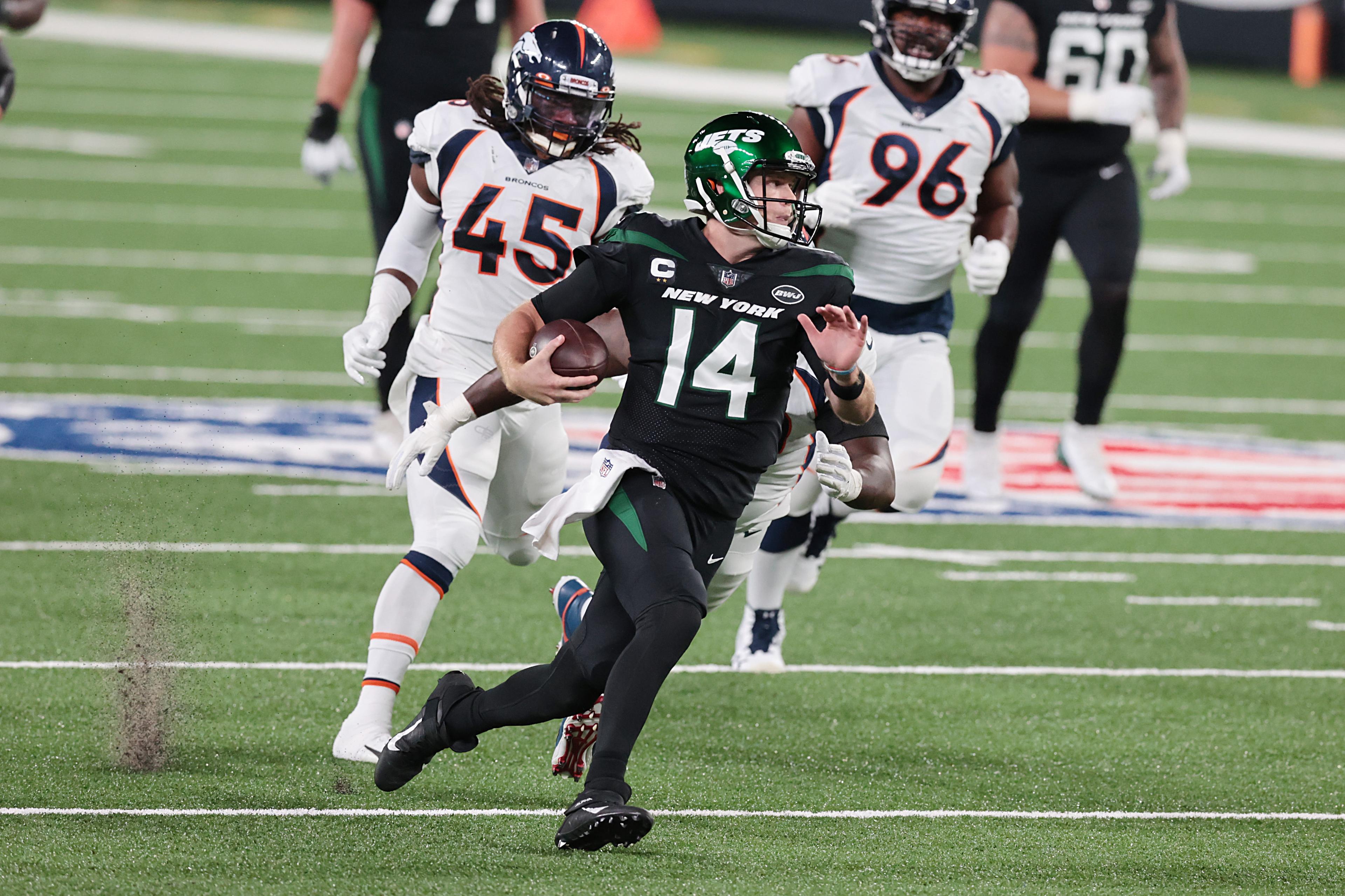 New York Jets quarterback Sam Darnold (14) breaks a tackle by Denver Broncos inside linebacker A.J. Johnson (45) for a touchdown at MetLife Stadium. / Vincent Carchietta - USA TODAY Sports