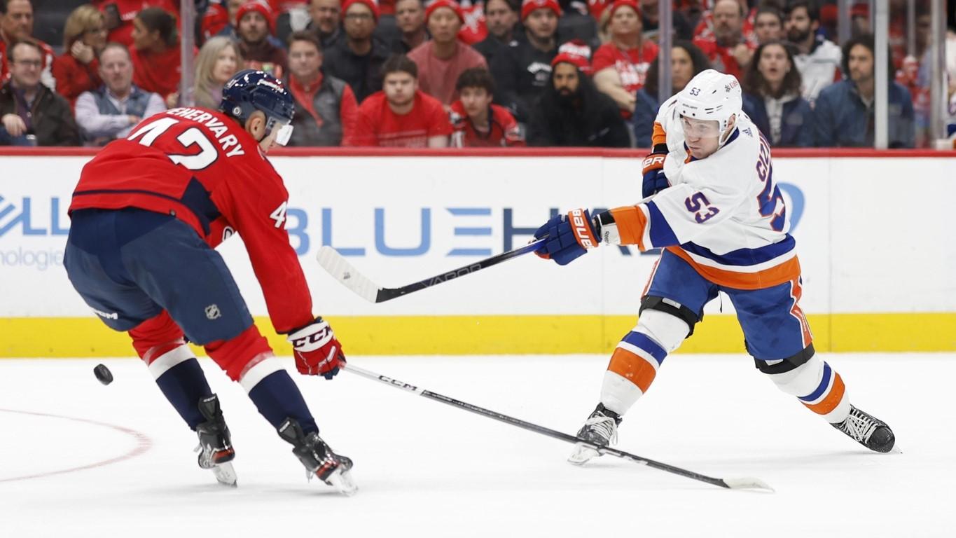 Dec 20, 2023; Washington, District of Columbia, USA; New York Islanders center Casey Cizikas (53) shoots the puck as Washington Capitals defenseman Martin Fehervary (42) defends in the second period at Capital One Arena. / Geoff Burke-USA TODAY Sports