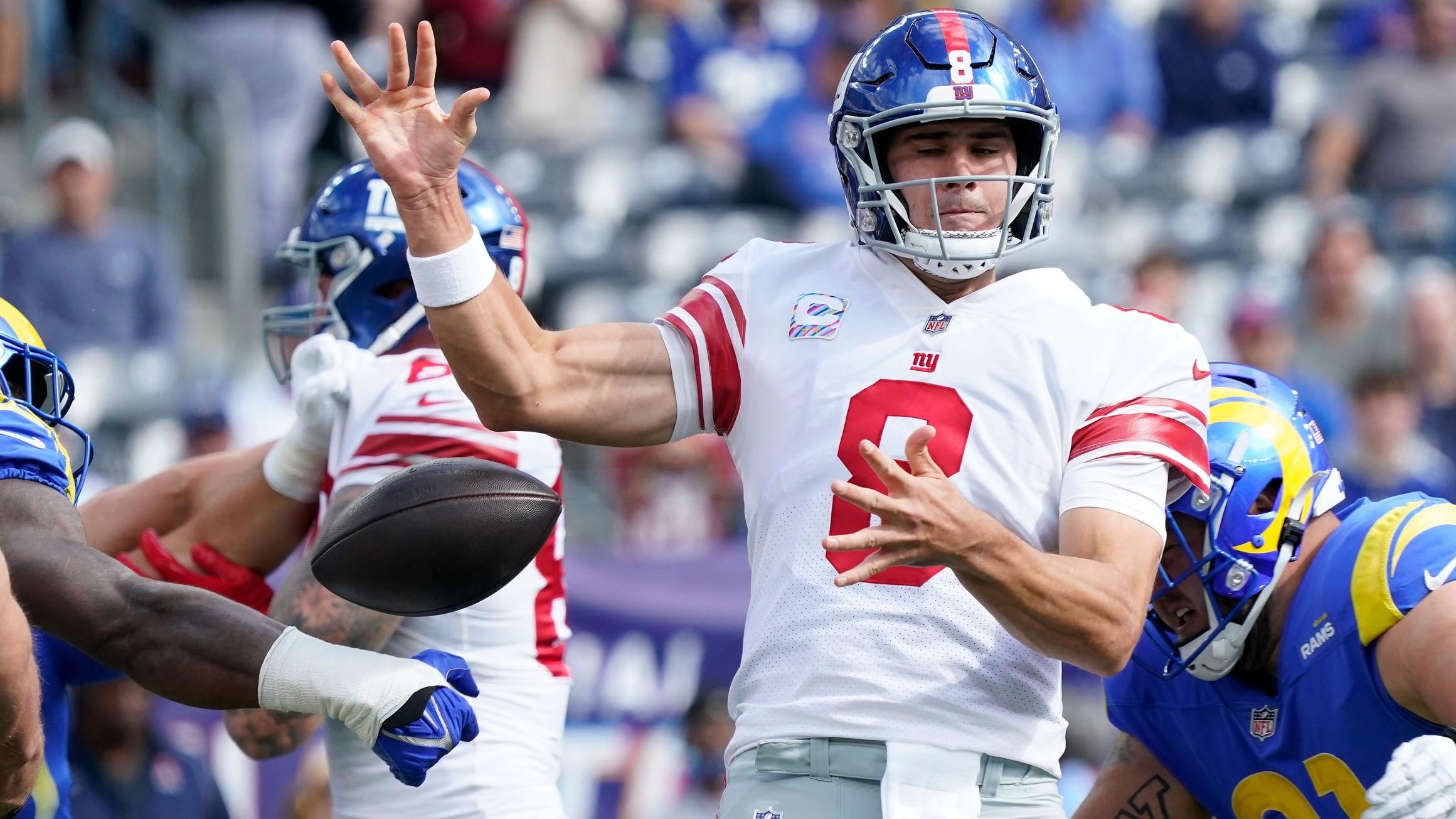 Oct 17, 2021; East Rutherford, New Jersey, USA; New York Giants quarterback Daniel Jones (8) is stripped of the ball in the 1st quarter against the Los Angeles Rams at MetLife Stadium. / Robert Deutsch-USA TODAY Sports