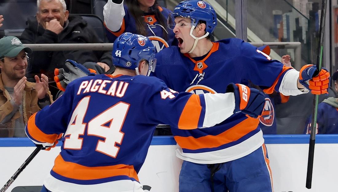 New York Islanders center Mathew Barzal (13) celebrates his game winning goal against the Toronto Maple Leafs with center Jean-Gabriel Pageau (44) during overtime at UBS Arena. / Brad Penner-USA TODAY Sports