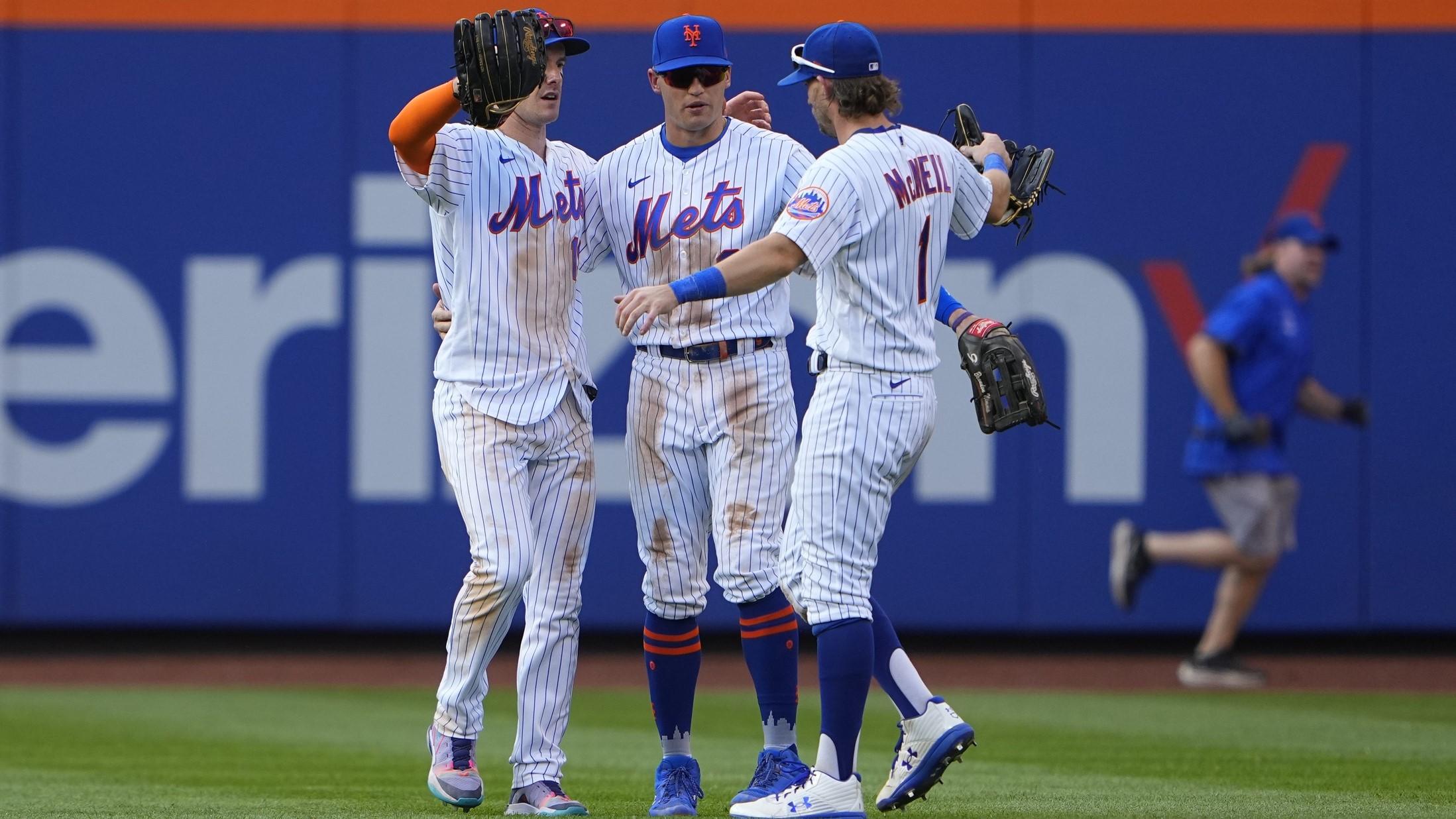 Sep 18, 2022; New York City, New York, USA; New York Mets left fielder Mark Canha (19) and center fielder Brandon Nimmo (9) and right fielder Jeff McNeil (1) embrace after defeating the Pittsburgh Pirates at Citi Field. / Gregory Fisher-USA TODAY Sports