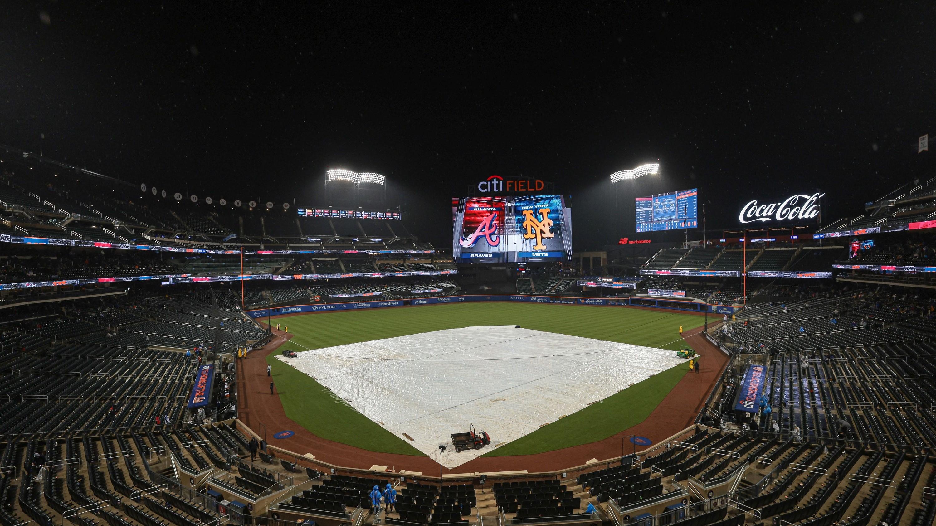 Apr 28, 2023; New York City, New York, USA; The tarp covers the field during a rain delay after the bottom of the fifth inning of the MLB National League game between the New York Mets and the Atlanta Braves at Citi Field. / Vincent Carchietta-USA TODAY Sports