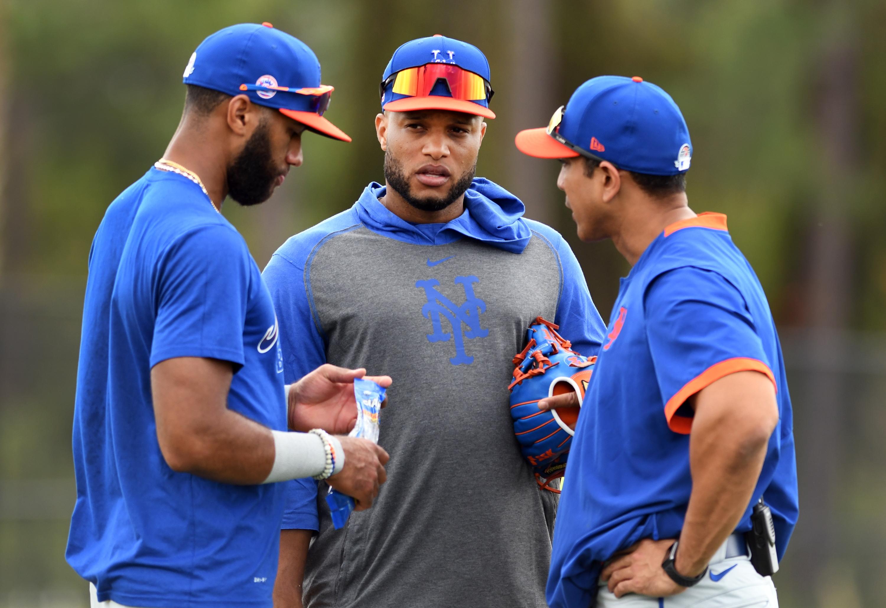 Feb 18, 2020; Port St. Lucie, Florida, USA; New York Mets infielder Robinson Cano speaks with manager Luis Rojas (right) and infielder Amed Rosario during infield practice at spring training. Mandatory Credit: Jim Rassol-USA TODAY Sports / Jim Rassol-USA TODAY Sports