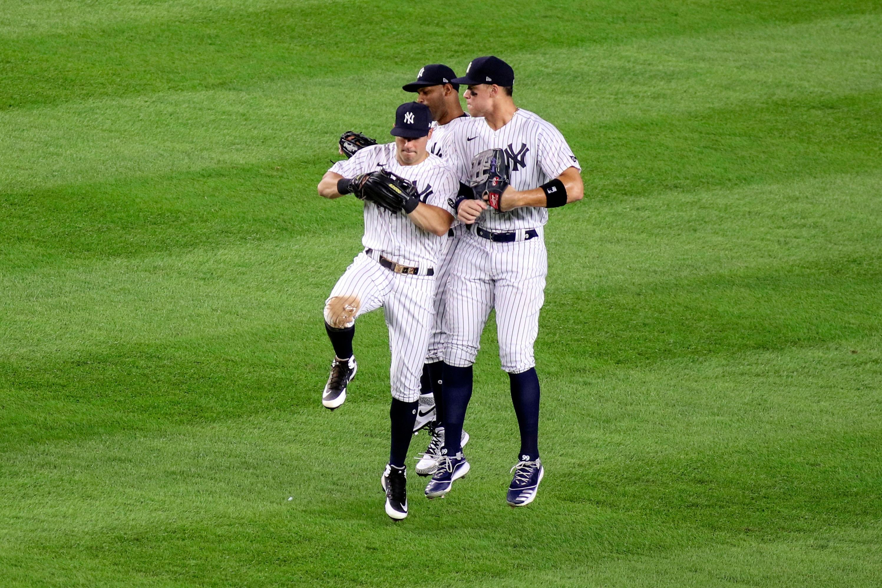 Aug 2, 2020; Bronx, New York, USA; New York Yankees outfielders Mike Tauchman (39), Aaron Hicks (31) and Aaron Judge (99) celebrate a 9-7 victory over the Boston Red Sox at Yankee Stadium. Mandatory Credit: Wendell Cruz-USA TODAY Sports / © Wendell Cruz-USA TODAY Sports