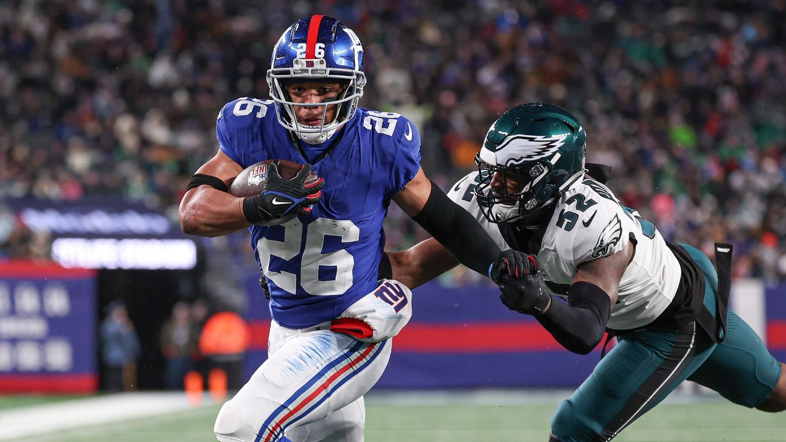 Jan 7, 2024; East Rutherford, New Jersey, USA; New York Giants running back Saquon Barkley (26) breaks a tackle by Philadelphia Eagles linebacker Zach Cunningham (52) for a rushing touchdown during the first half at MetLife Stadium. / Vincent Carchietta-USA TODAY Sports