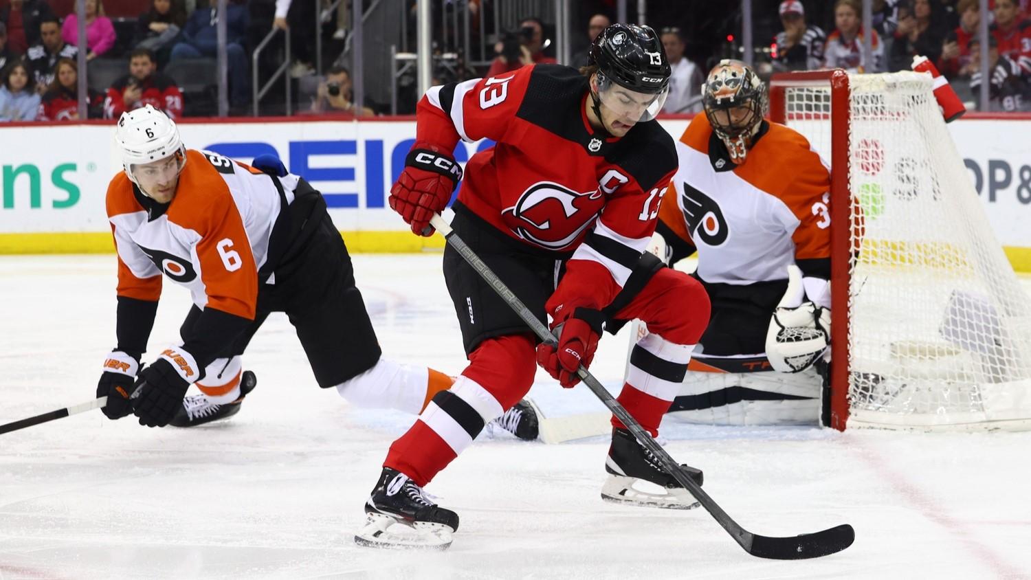 Dec 19, 2023; Newark, New Jersey, USA; New Jersey Devils center Nico Hischier (13) skates with the puck against the Philadelphia Flyers during the second period at Prudential Center. / Ed Mulholland-USA TODAY Sports
