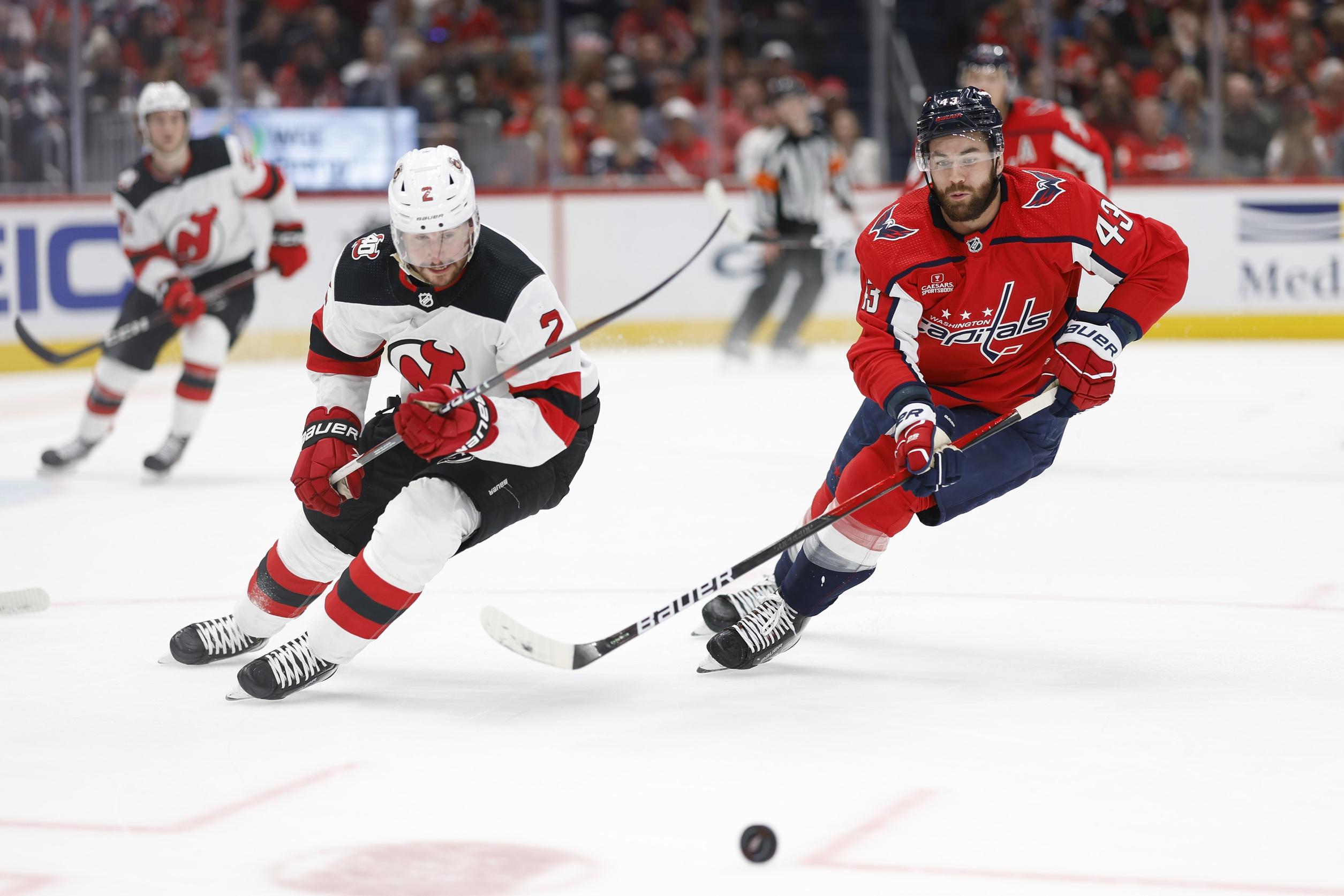 New Jersey Devils defenseman Brendan Smith (2) and Washington Capitals right wing Tom Wilson (43) battle for the puck in the second period at Capital One Arena. / Geoff Burke-USA TODAY Sports