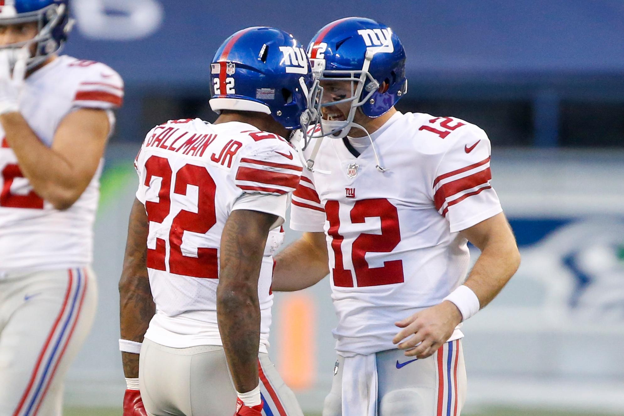 Dec 6, 2020; Seattle, Washington, USA; New York Giants quarterback Colt McCoy (12) celebrates with running back Wayne Gallman (22) before the final play of a 17-12 victory against the Seattle Seahawks at Lumen Field / © Joe Nicholson-USA TODAY Sports