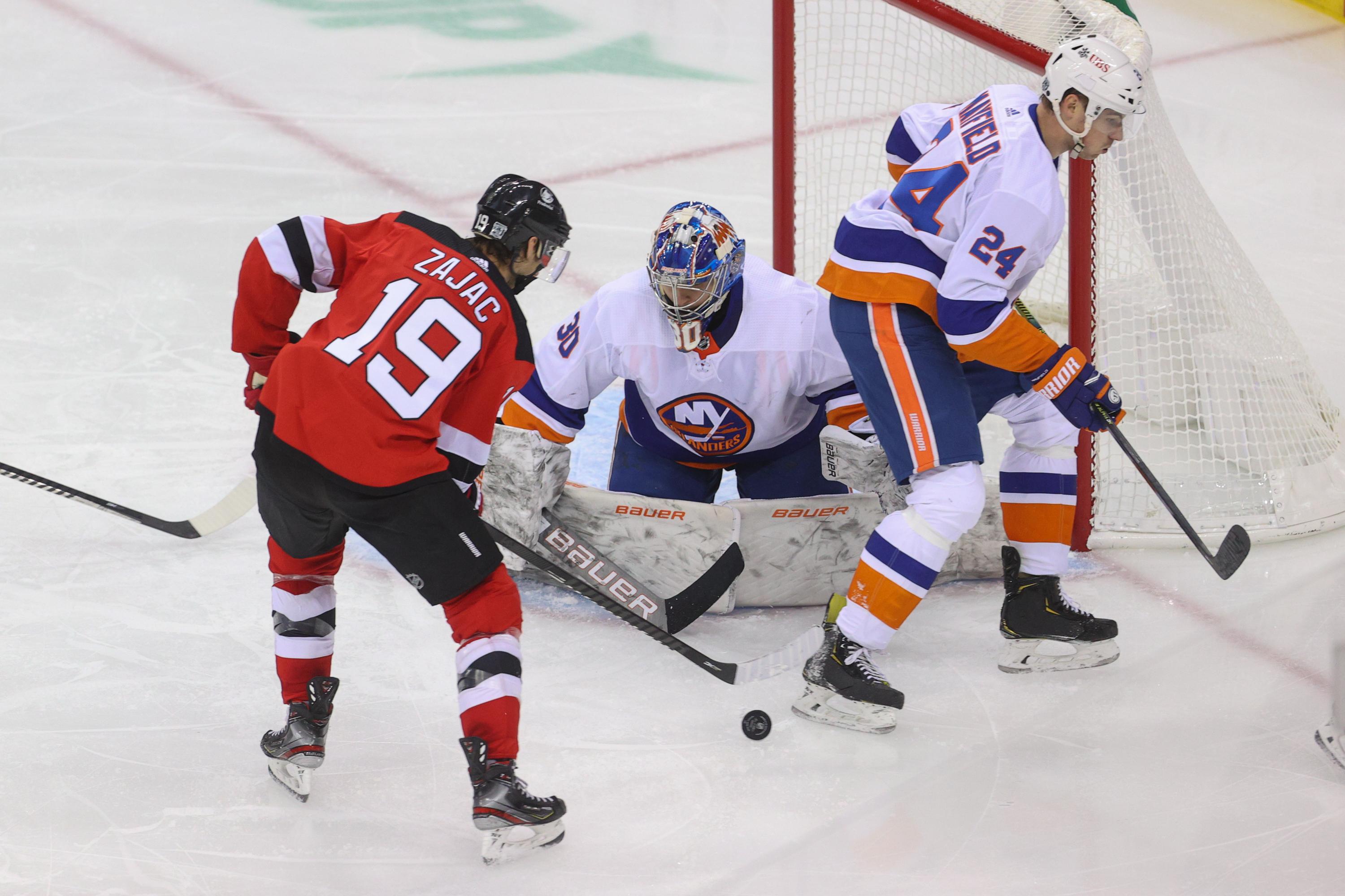 Jan 24, 2021; Newark, New Jersey, USA; New Jersey Devils center Travis Zajac (19) plays the puck in front of New York Islanders goaltender Ilya Sorokin (30) during the second period at Prudential Center. Mandatory Credit: Ed Mulholland-USA TODAY Sports / © Ed Mulholland-USA TODAY Sports