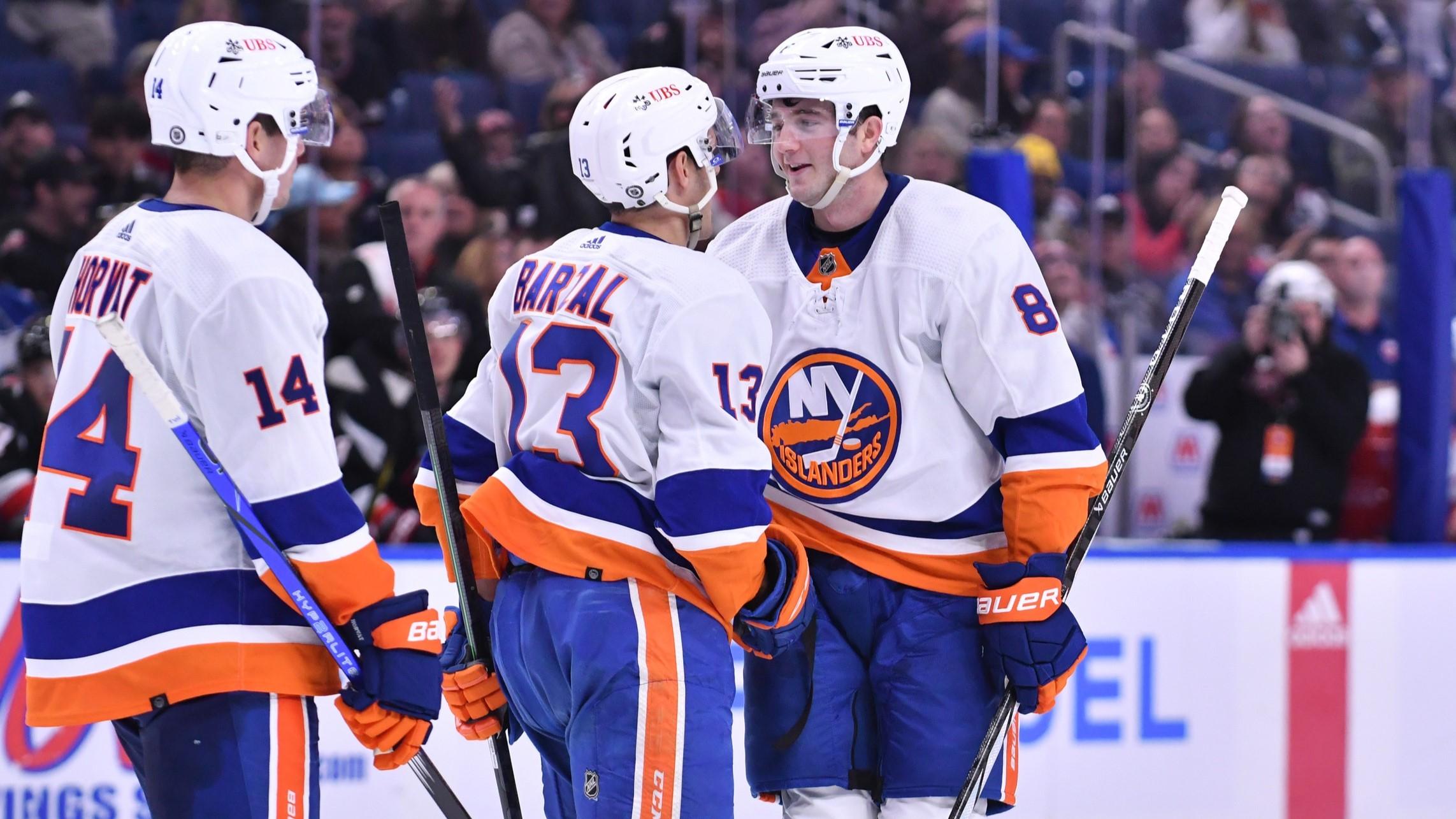 New York Islanders defenseman Noah Dobson (8) is congratulated by center Mathew Barzal (13) and center Bo Horvat (14) after scoring a goal against the Buffalo Sabres in the third period at KeyBank Center. / Mark Konezny-USA TODAY Sports
