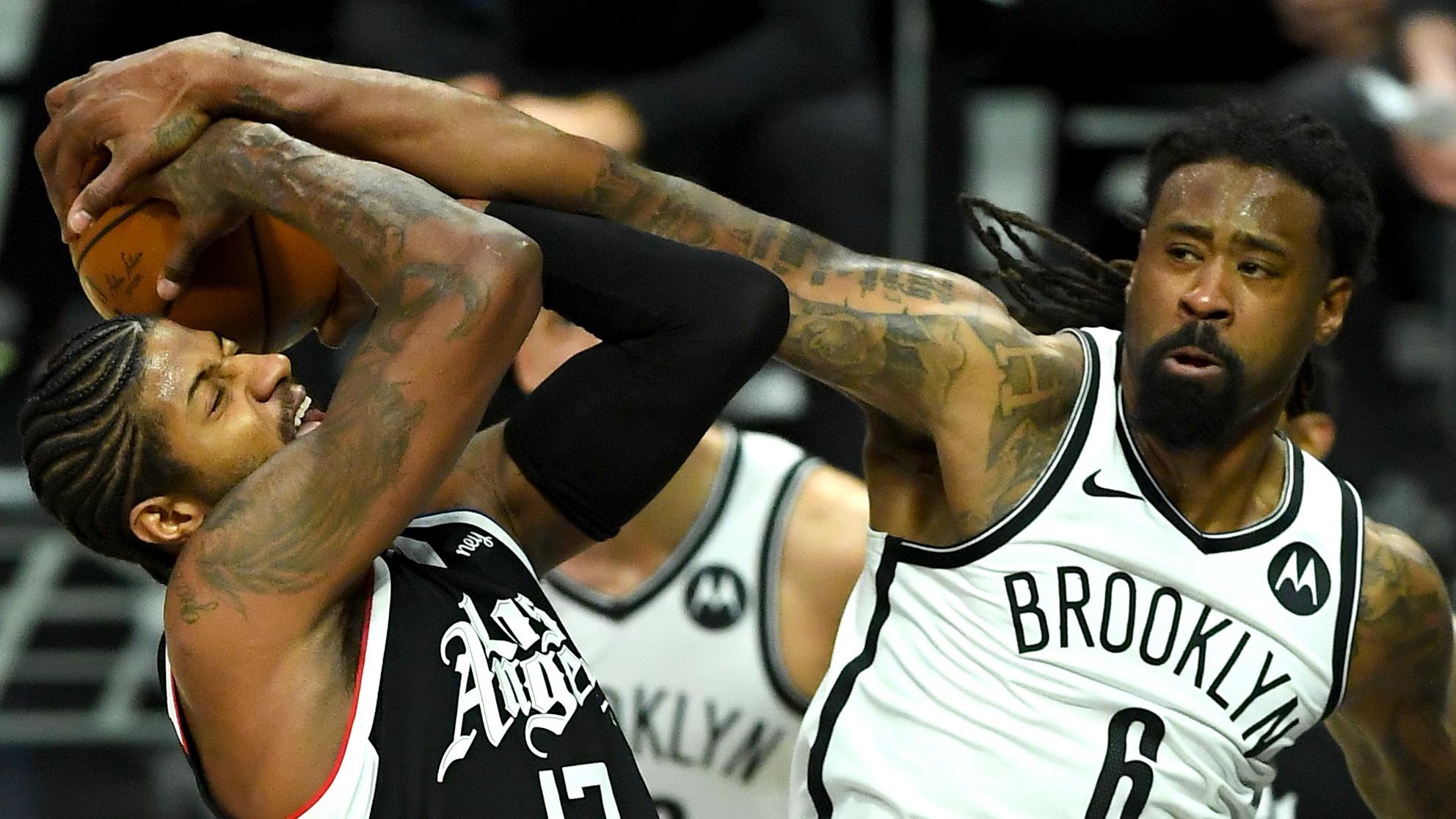 Feb 21, 2021; Los Angeles, California, USA; Los Angeles Clippers guard Paul George (13) is fouled by Brooklyn Nets center DeAndre Jordan (8) as he goes up for a basket in the fourth quarter of the game at Staples Center. / © Jayne Kamin-Oncea-USA TODAY Sports